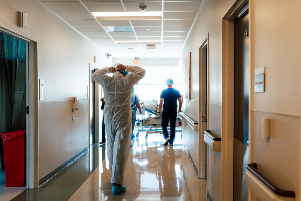 dad walking down the hallway in the hospital on the way to a cesarean section 
