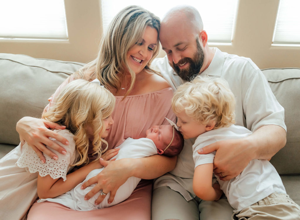 family together with newborn in their own home for a lifestyle newborn session 