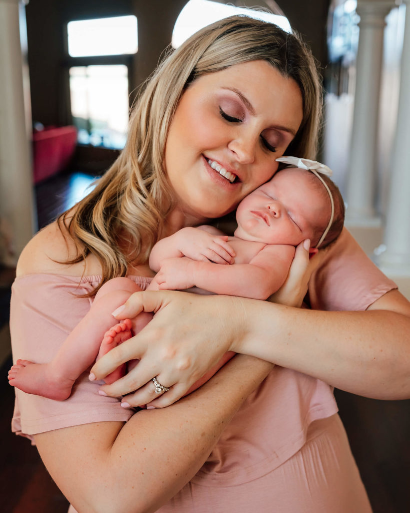 mom and baby posing during an in home newborn session 