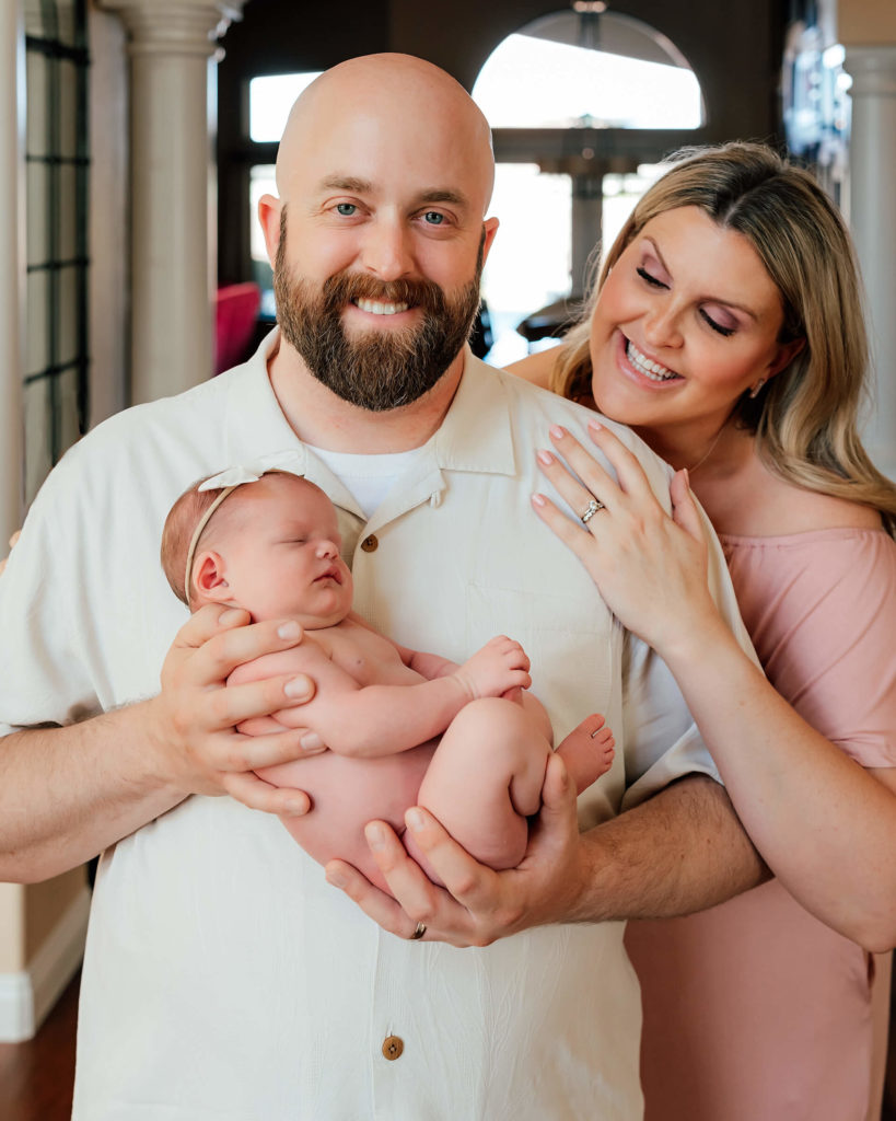 parents posed with baby in an in home newborn session 