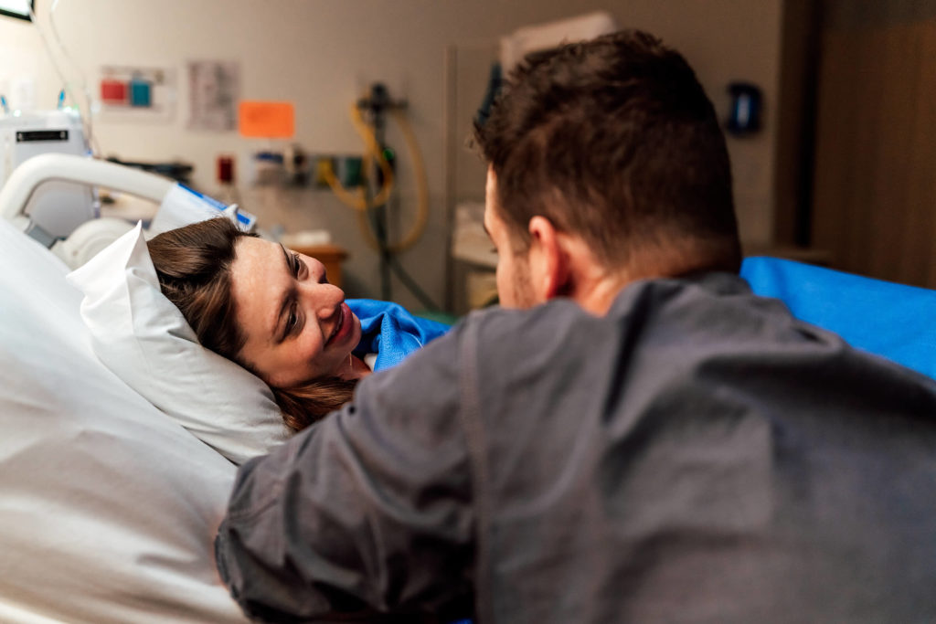 a couple interacting while in labor in a supportive and loving manner
