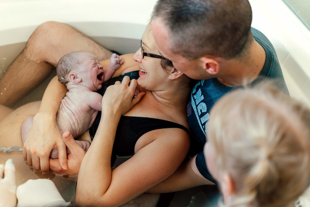 beautiful home birth at home with children surrounding mother after birth in Las Vegas, NV