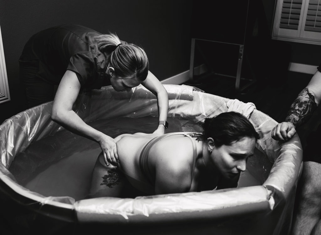 pressure applied to lower back of laboring mother by midwife during a home birth delivery in Las Vegas
