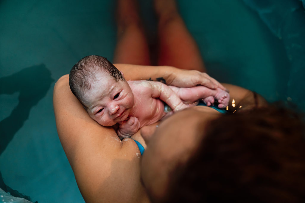 beautiful perspective of a mother holding her baby after a home birth in Las Vegas
