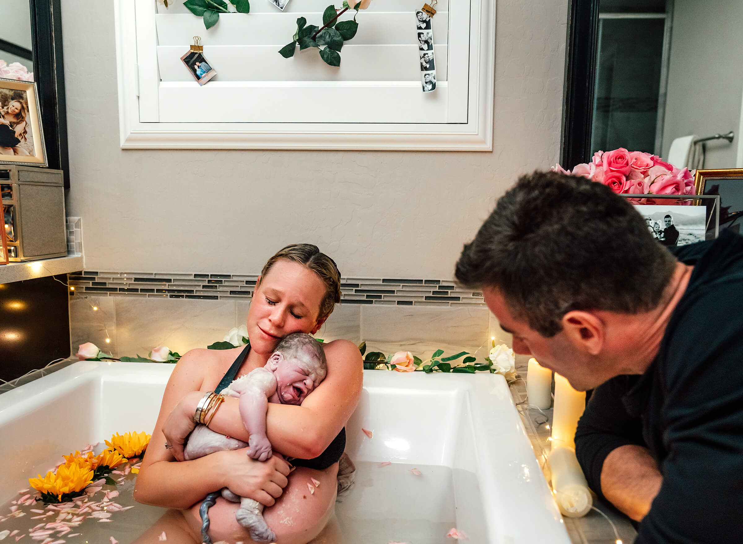 emotional mother holding her baby after birth at home in tub in Las Vegas 2019