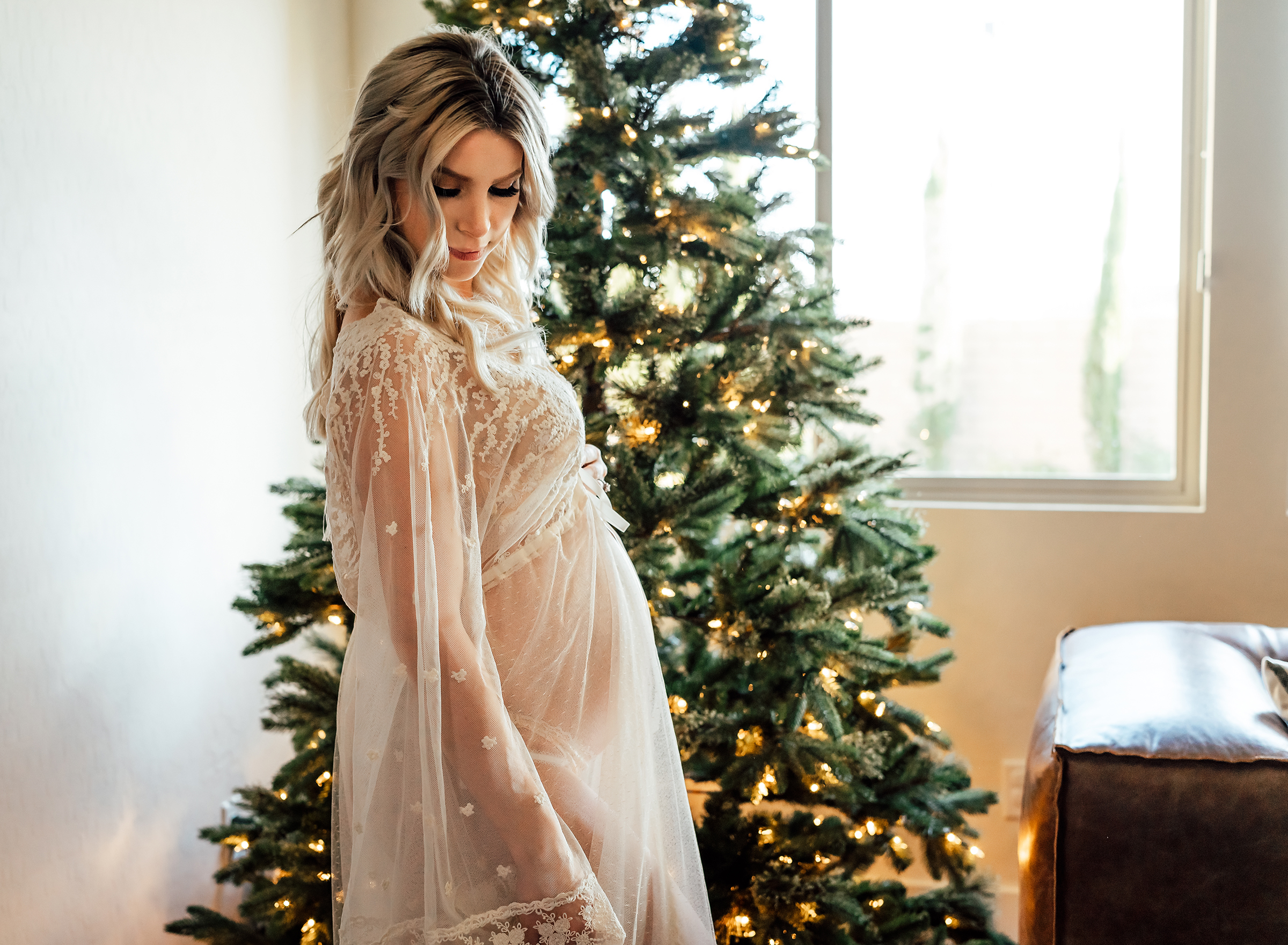 pregnant mother standing in front of her Christmas tree at home in Las Vegas