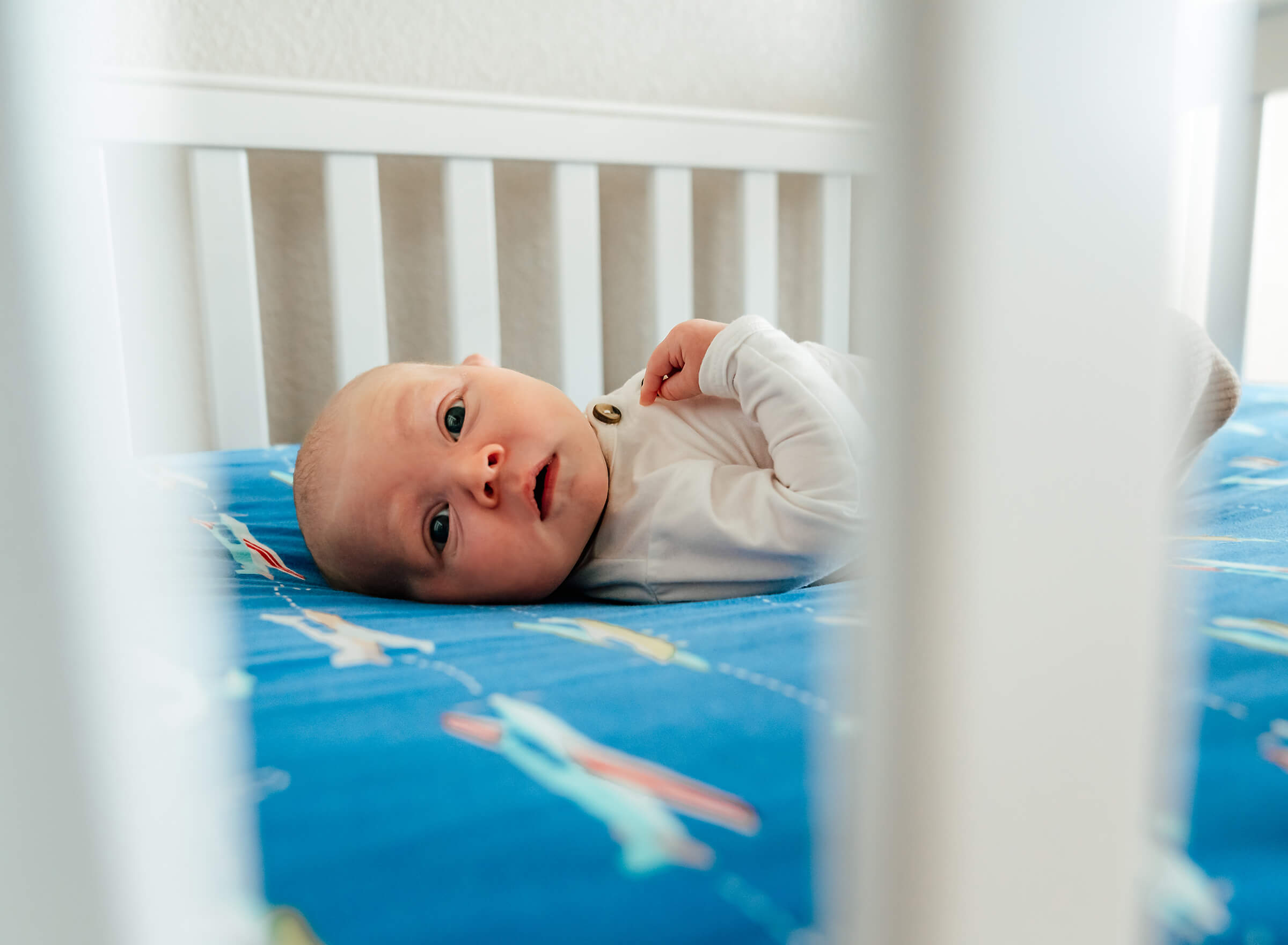 baby in his crib during an in-home newborn session