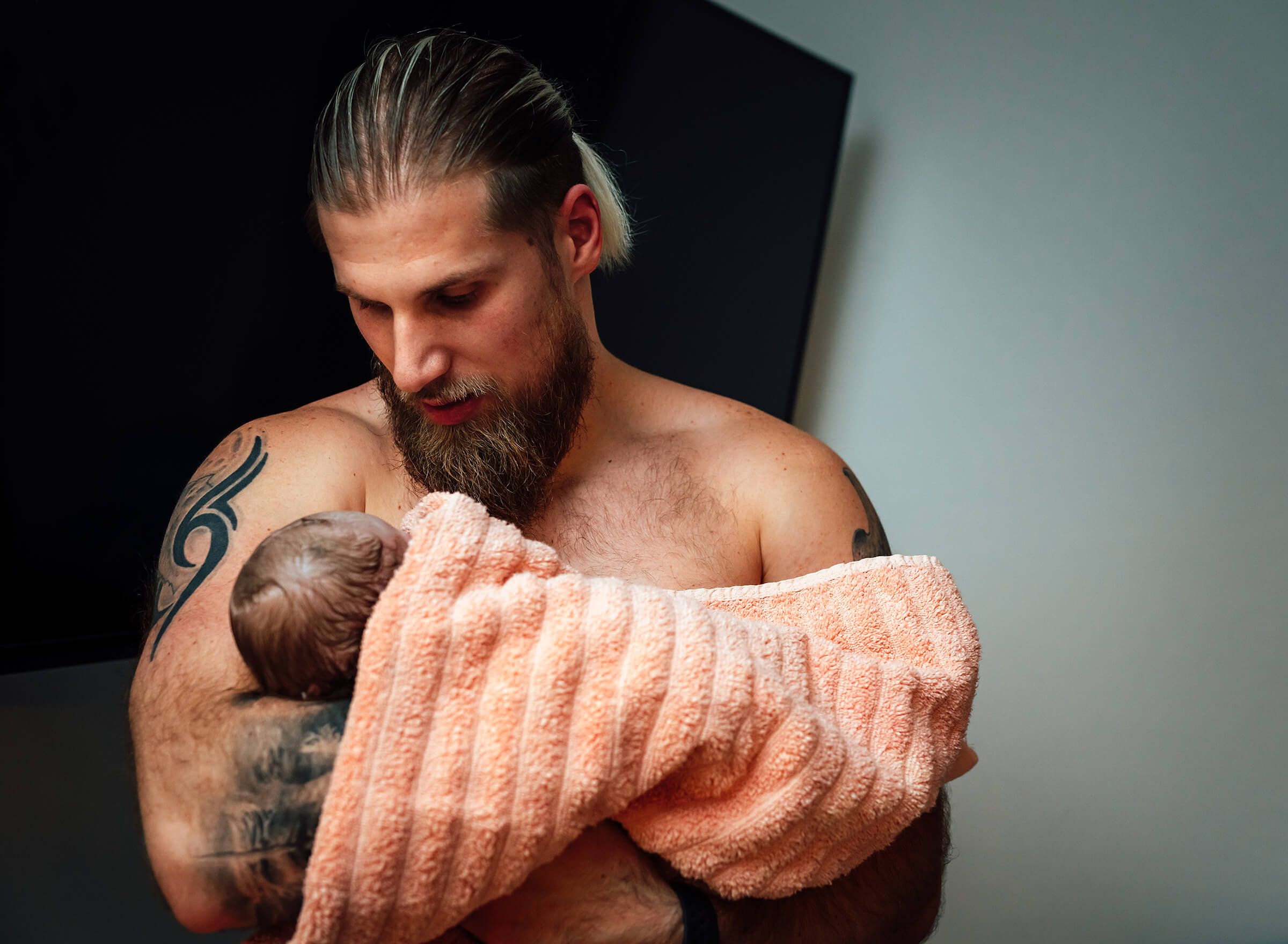 Anthony Prince holding his daughter after their birth at home