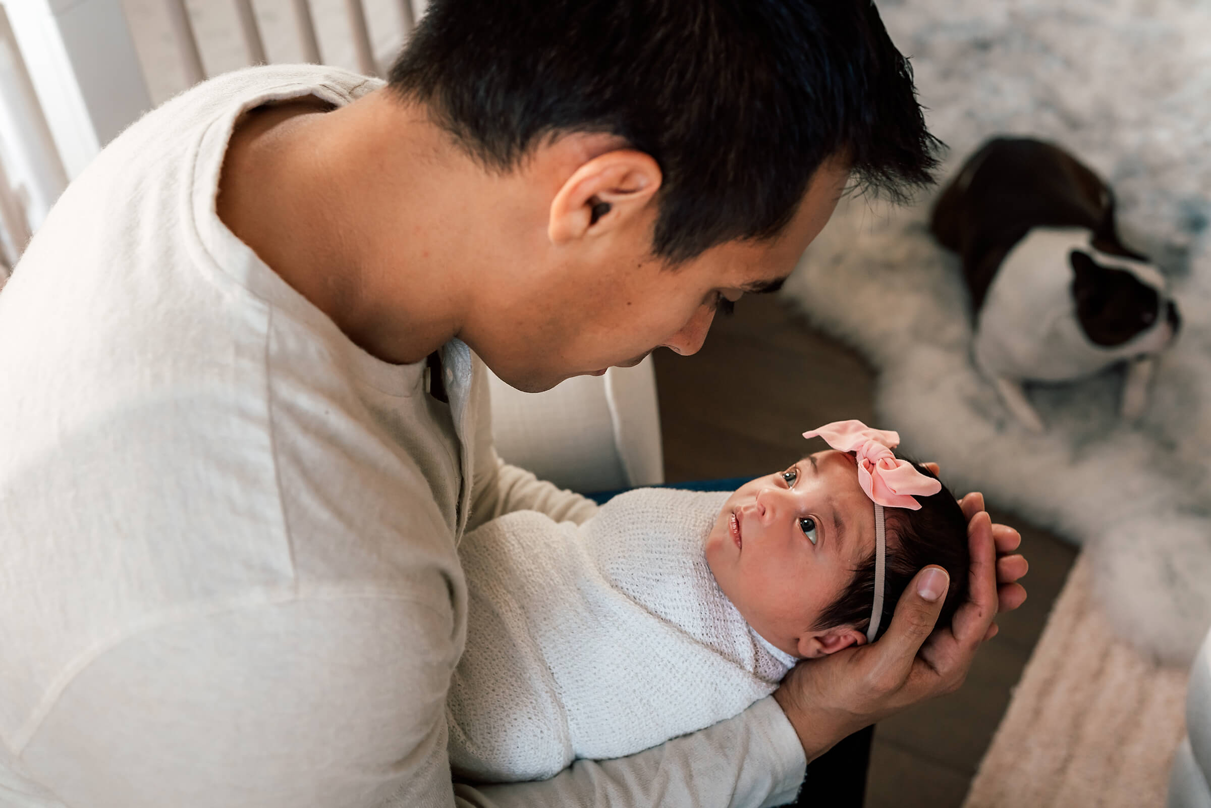 baby girl making eye contact with her dad during in home newborn session 