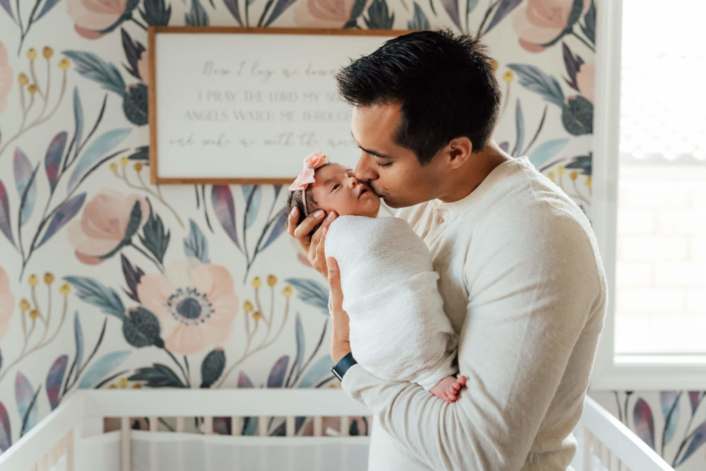 dad kissing baby during a lifestyle newborn session in Las Vegas