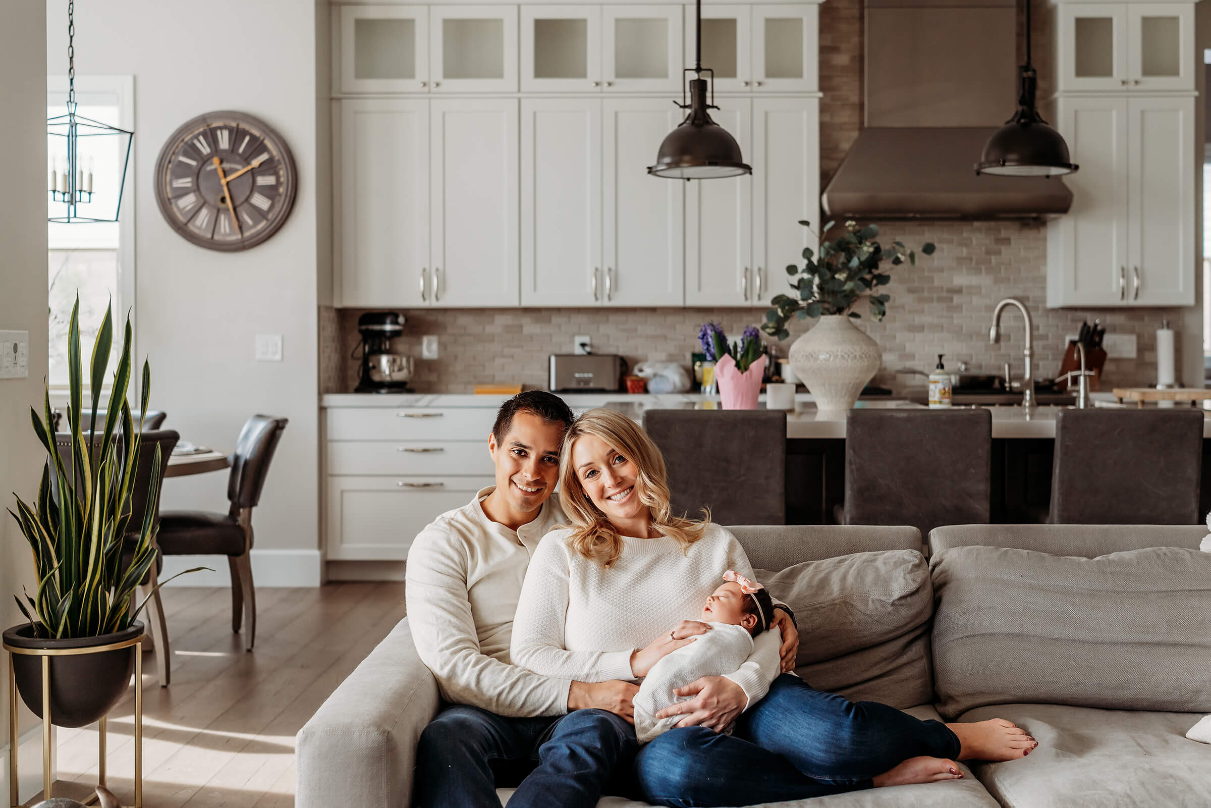 parents using their living room for lifestyle newborn session in Las Vegas
