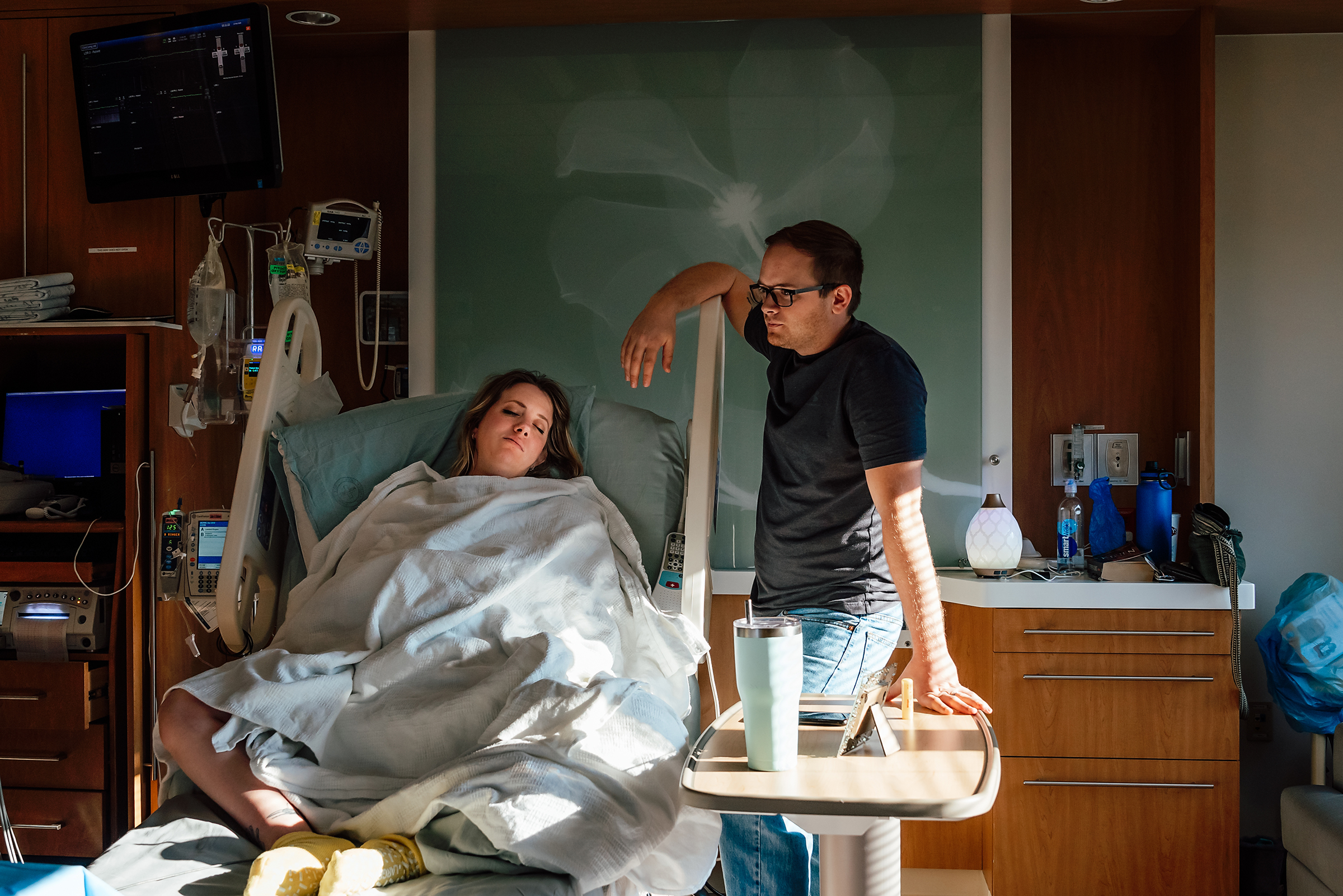 supportive husband at laboring wife's bedside in a Las Vegas hospital