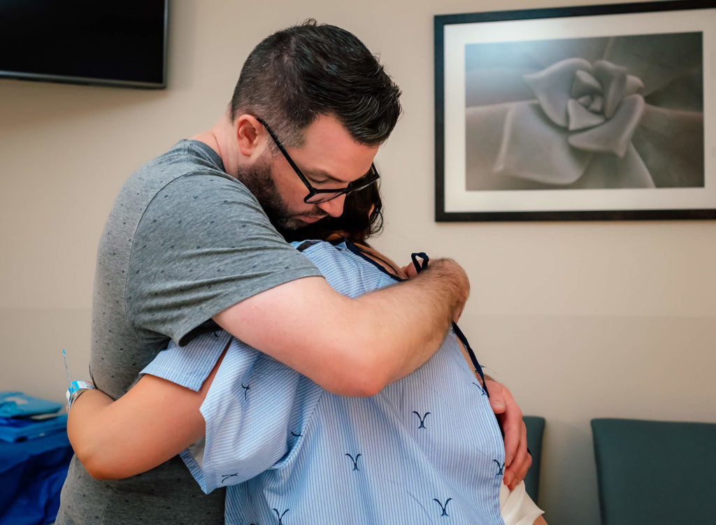 husband hugging wife while in labor 
