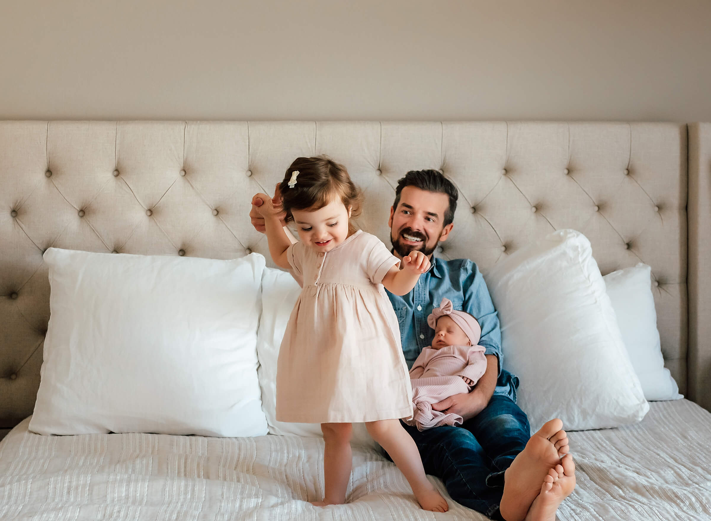 dad and his two daughters during in home newborn session 