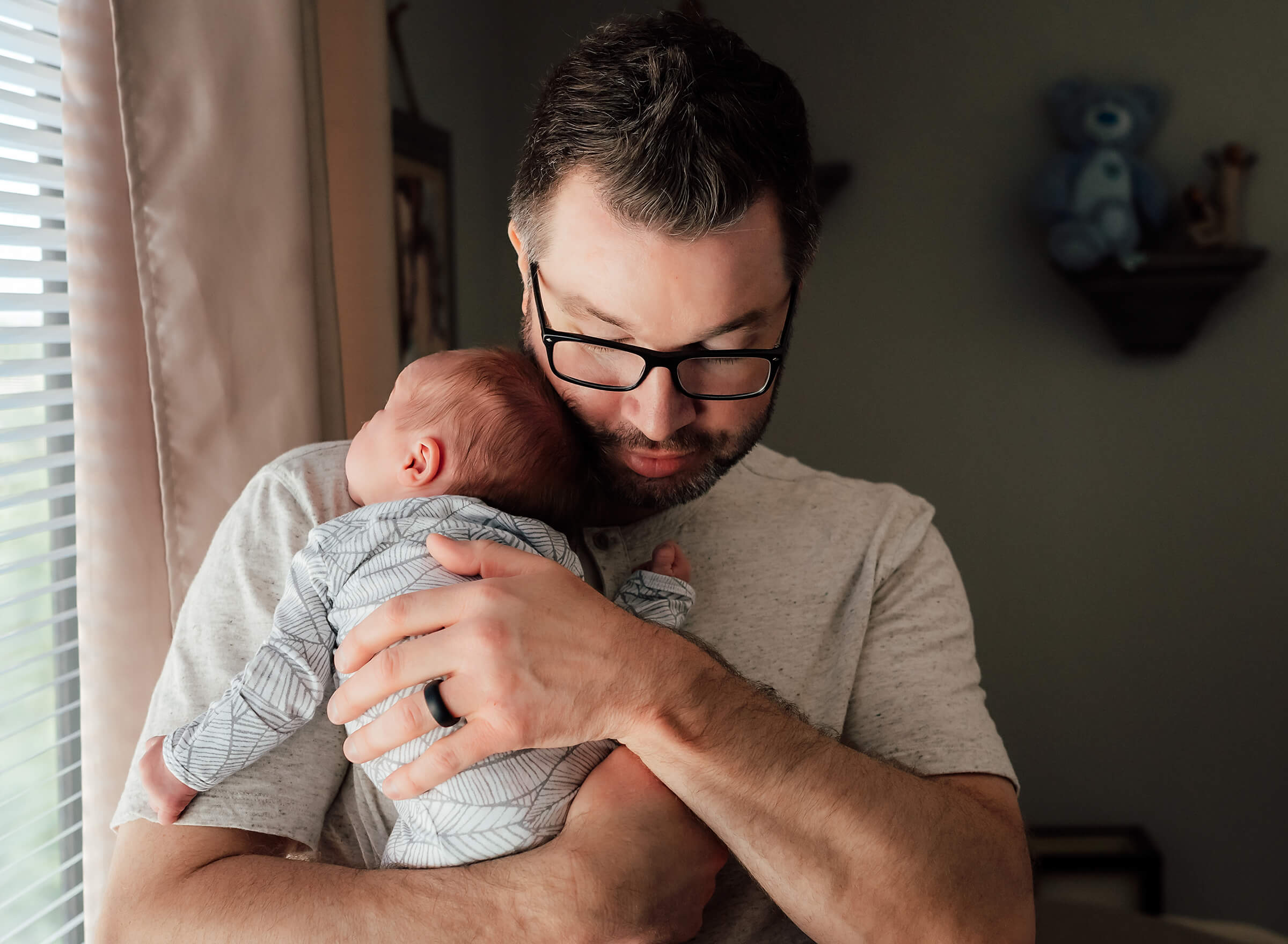 tender moment between dad and newborn son at home
