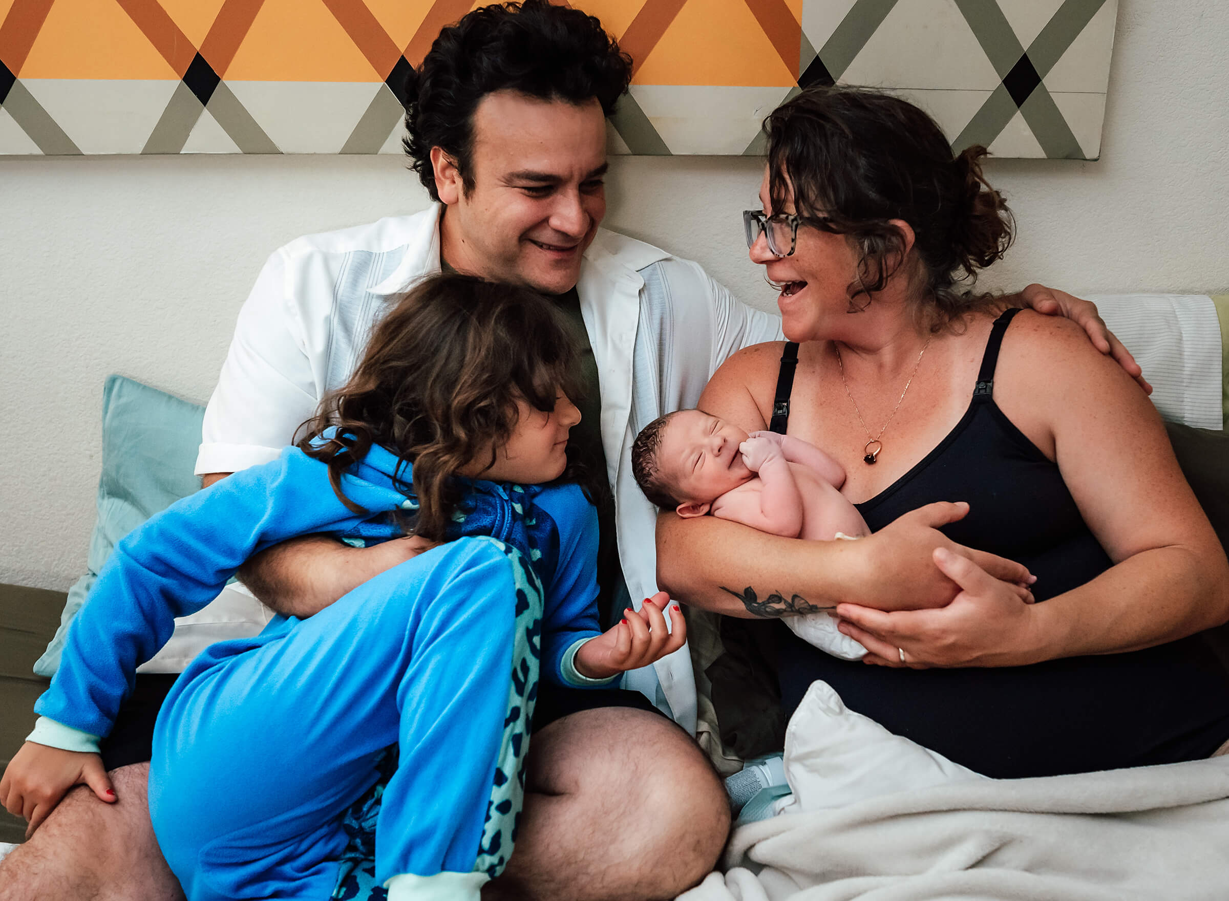 family together after a home birth on the bed