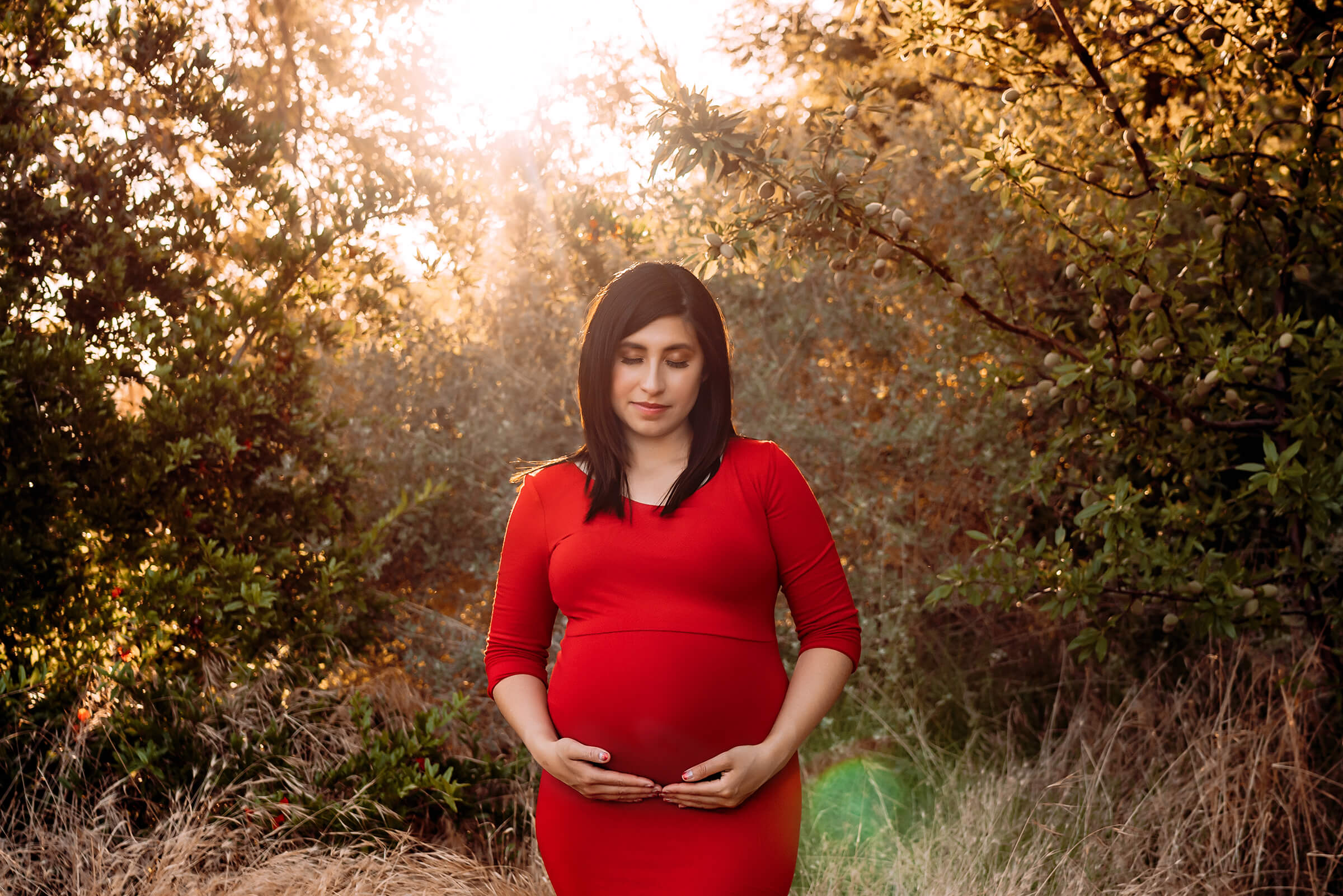 beautiful maternity session in Las Vegas wearing a red dress