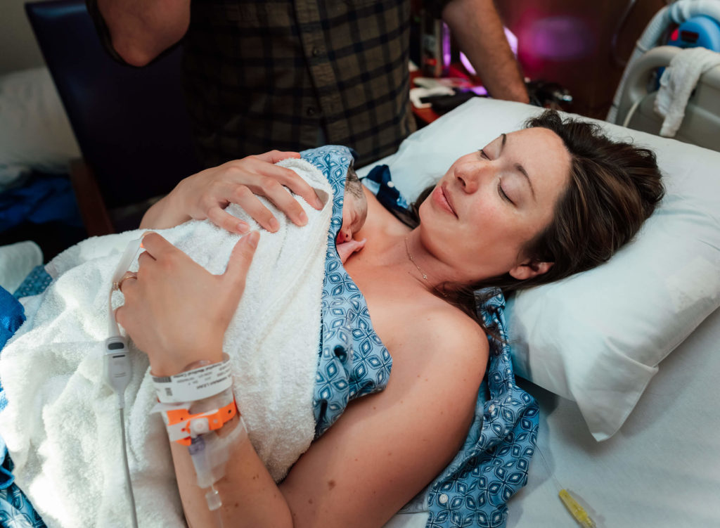 Hannah Neilsen holding her new baby after her delivery in Las Vegas