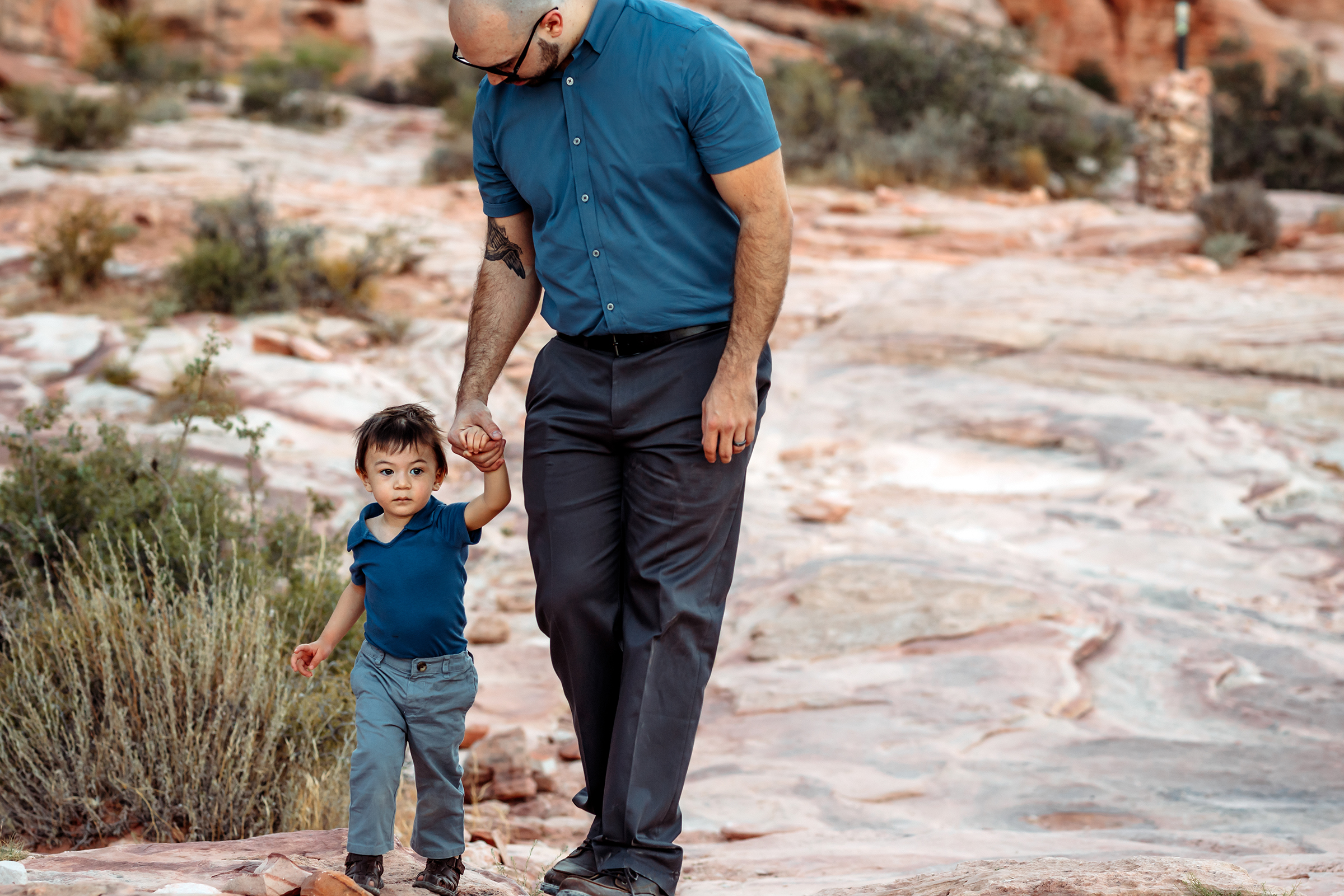 father walking with his young son holding hands