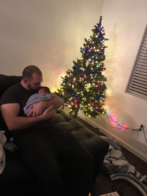 dad holding his son as he struggles through helping his wife through postpartum depression
