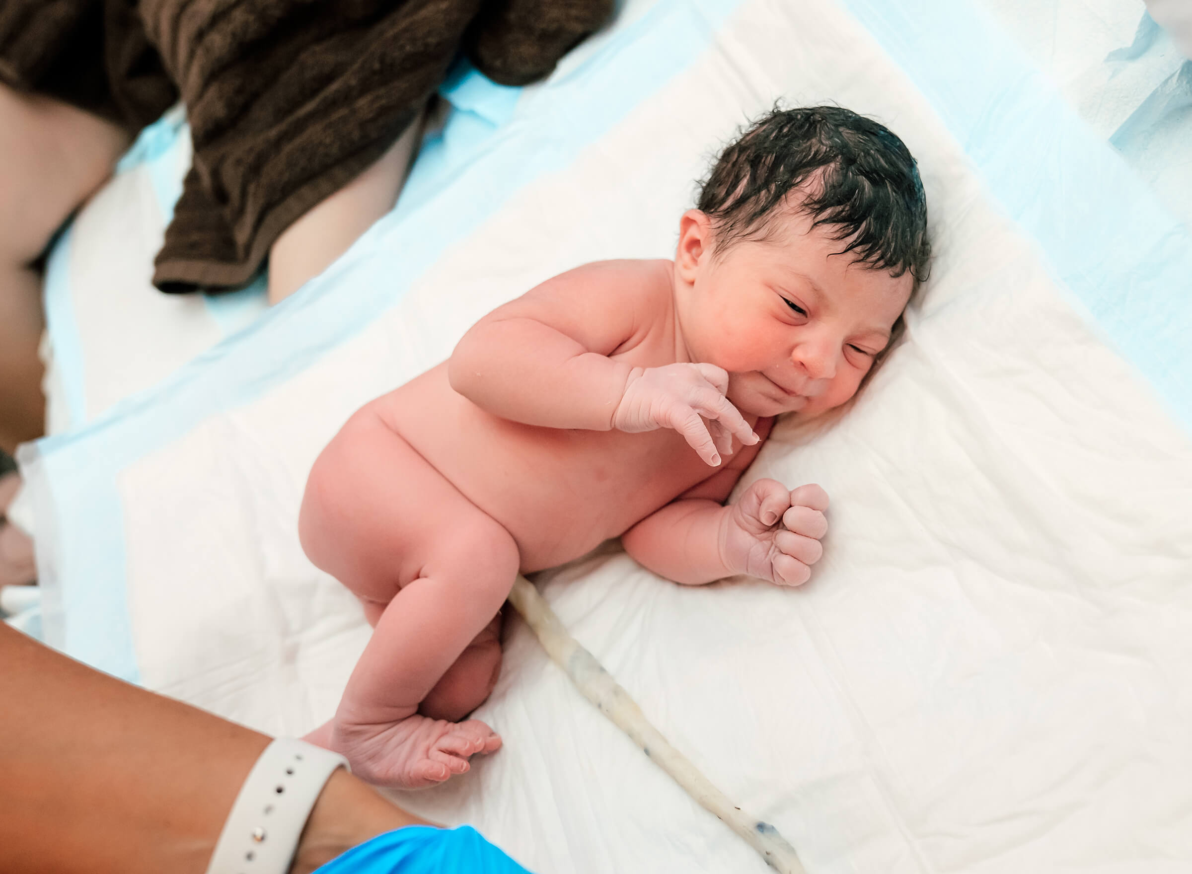 newborn still attached to placenta