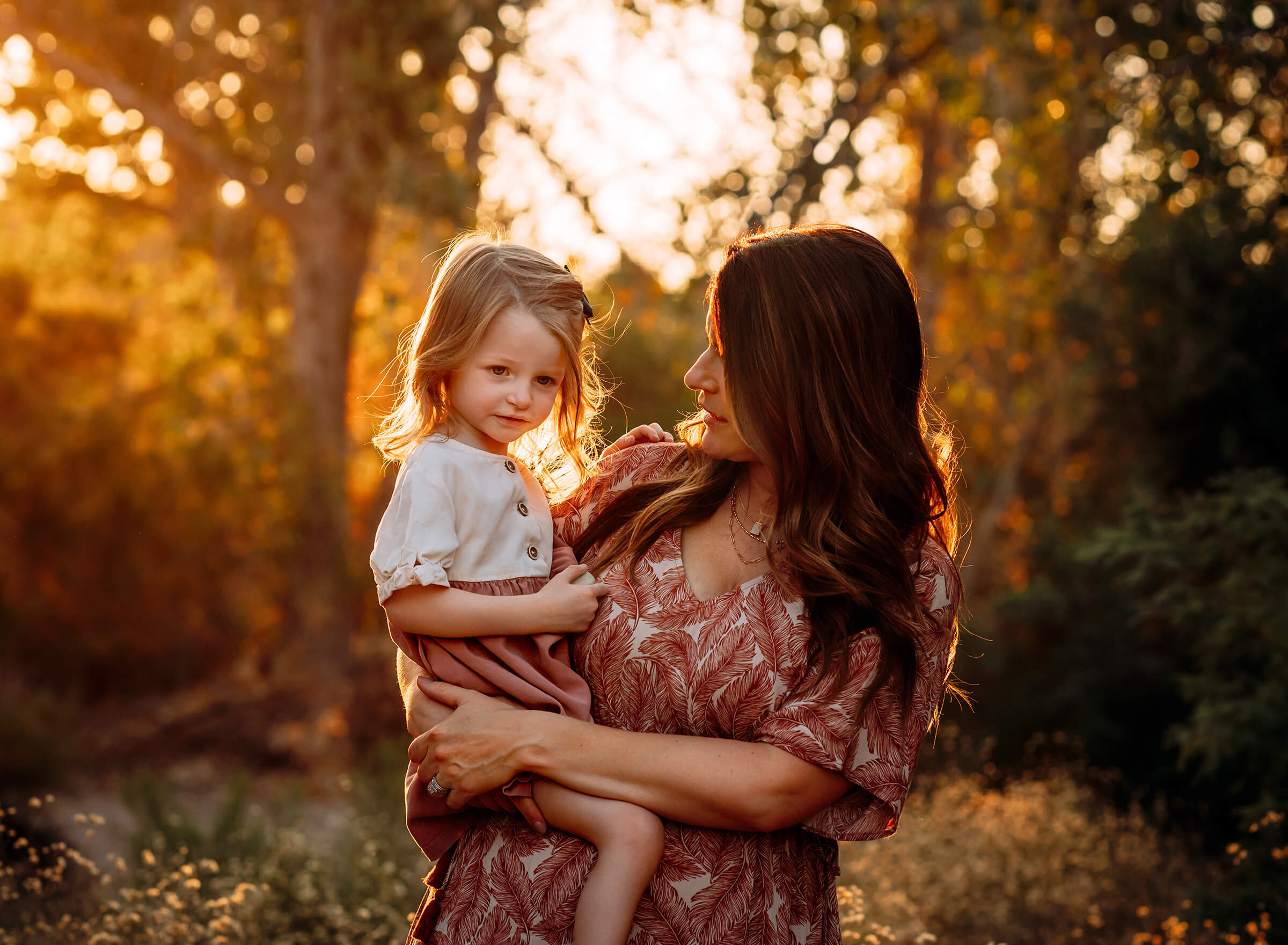 mom holding her four year old daughter during family session.