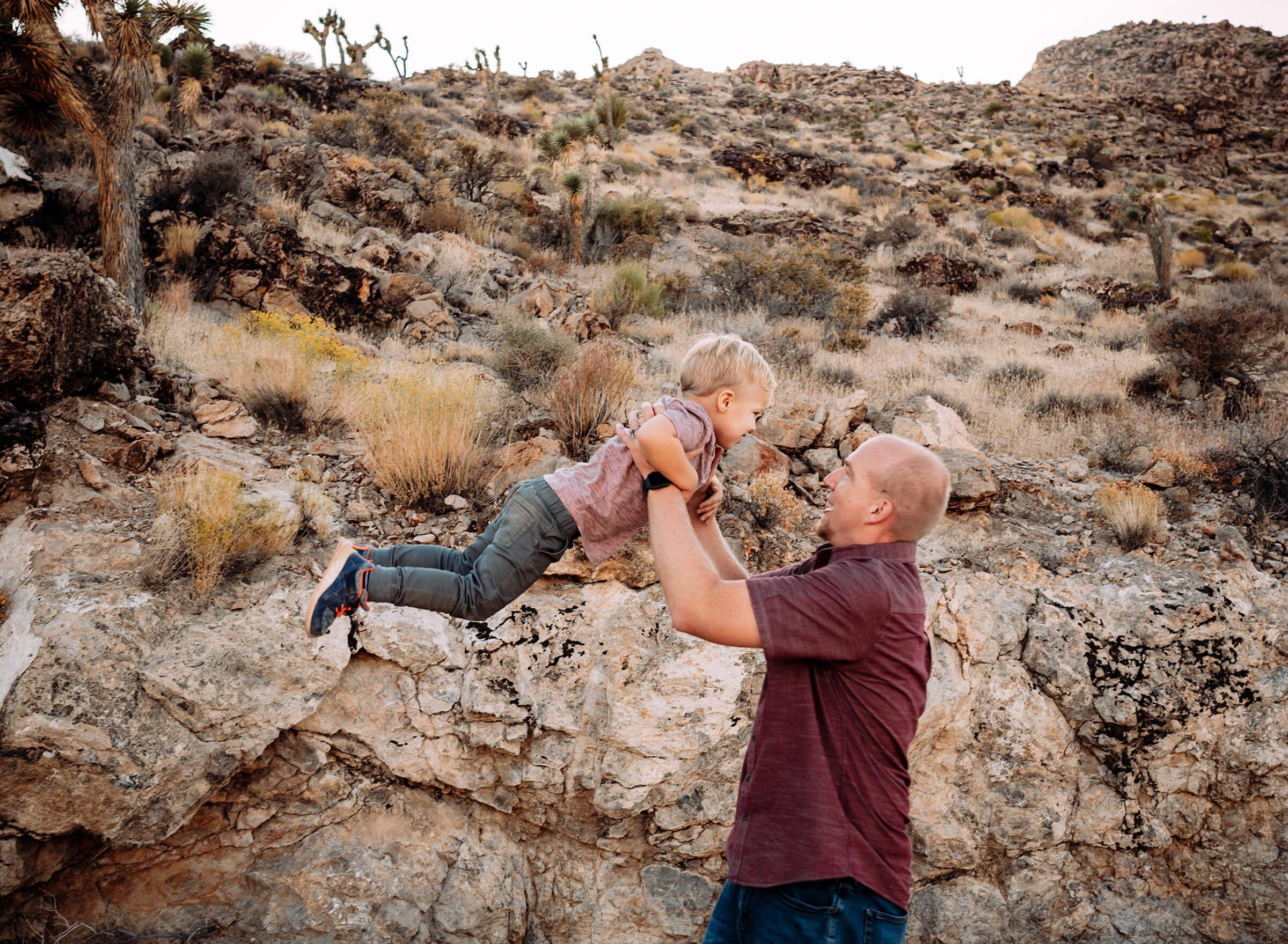 dad swinging his son in the air during a Las Vegas family session 