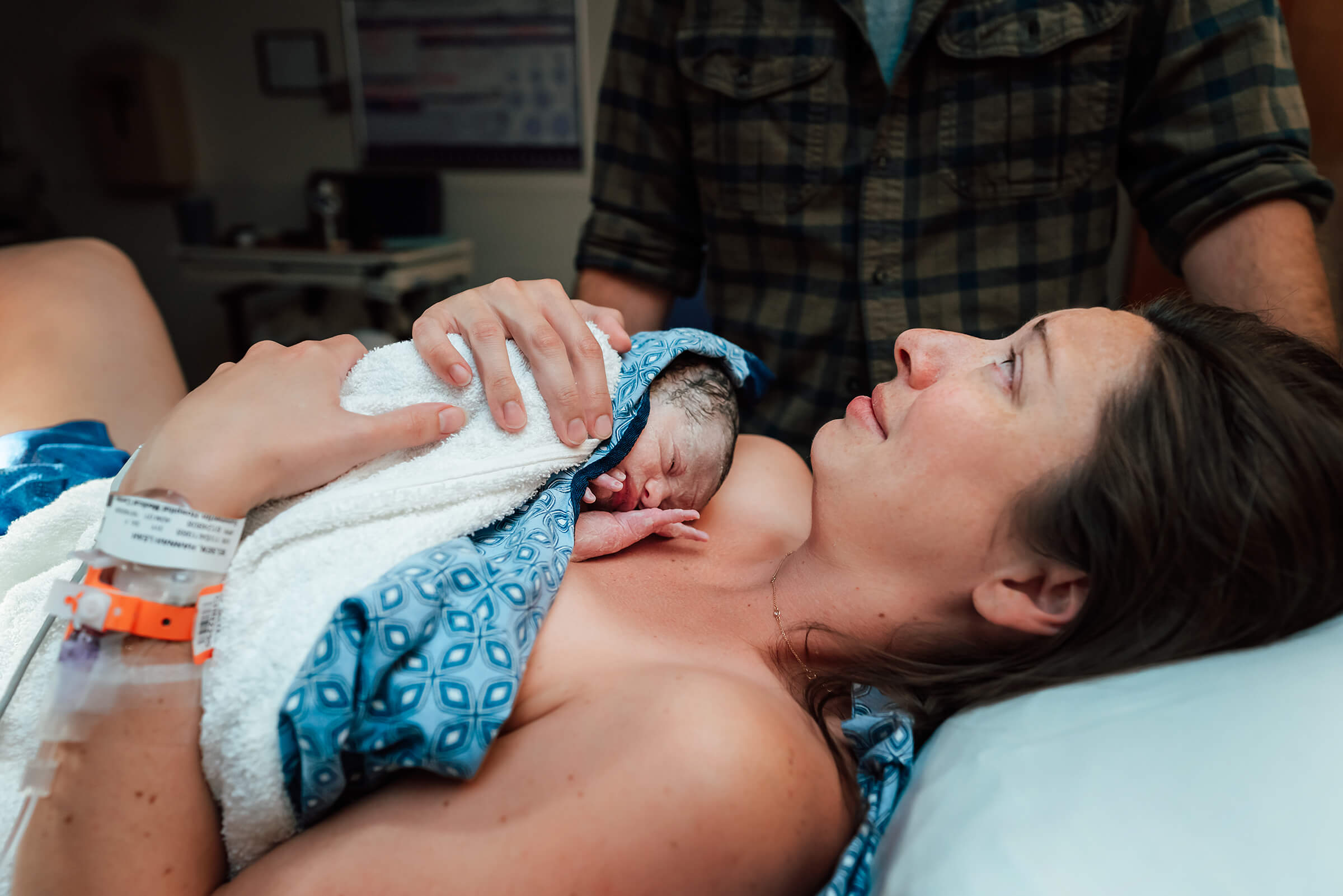 mother relieved after delivery with her daughter in her arms