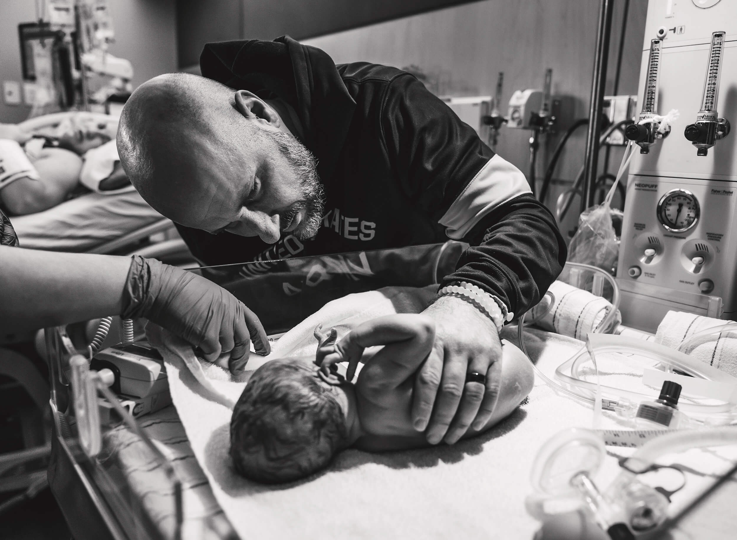 father checking every little detail on his newborn