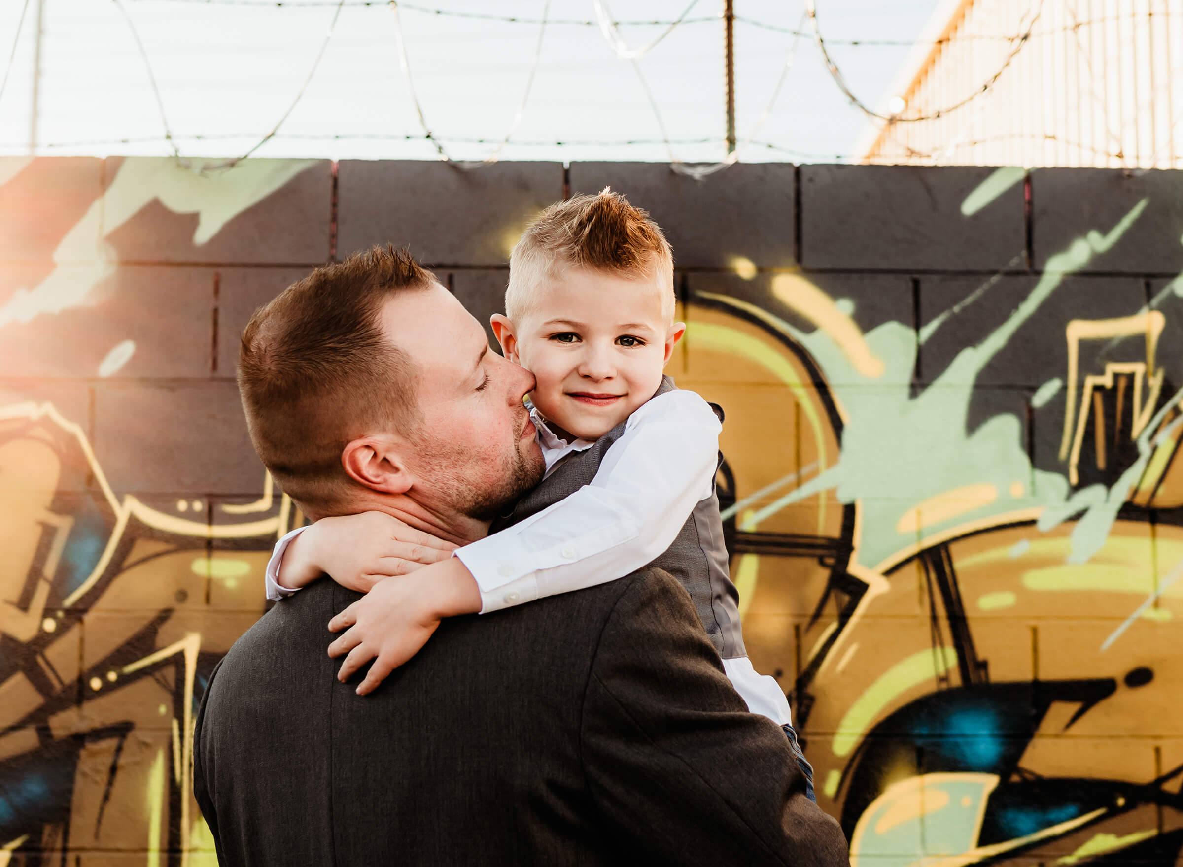 son hugging his dad during a family photography session 