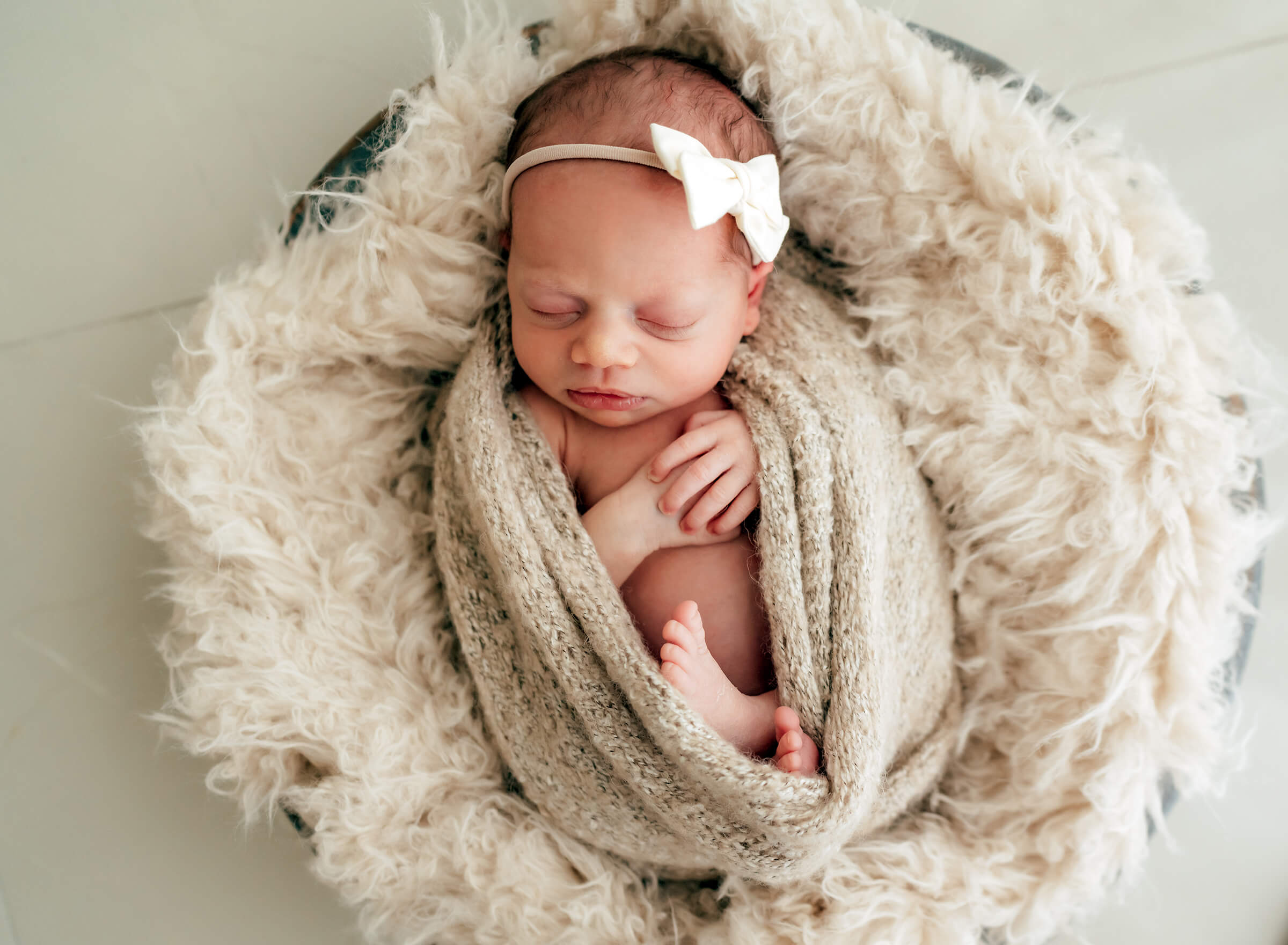 wrapped newborn using neutral colors