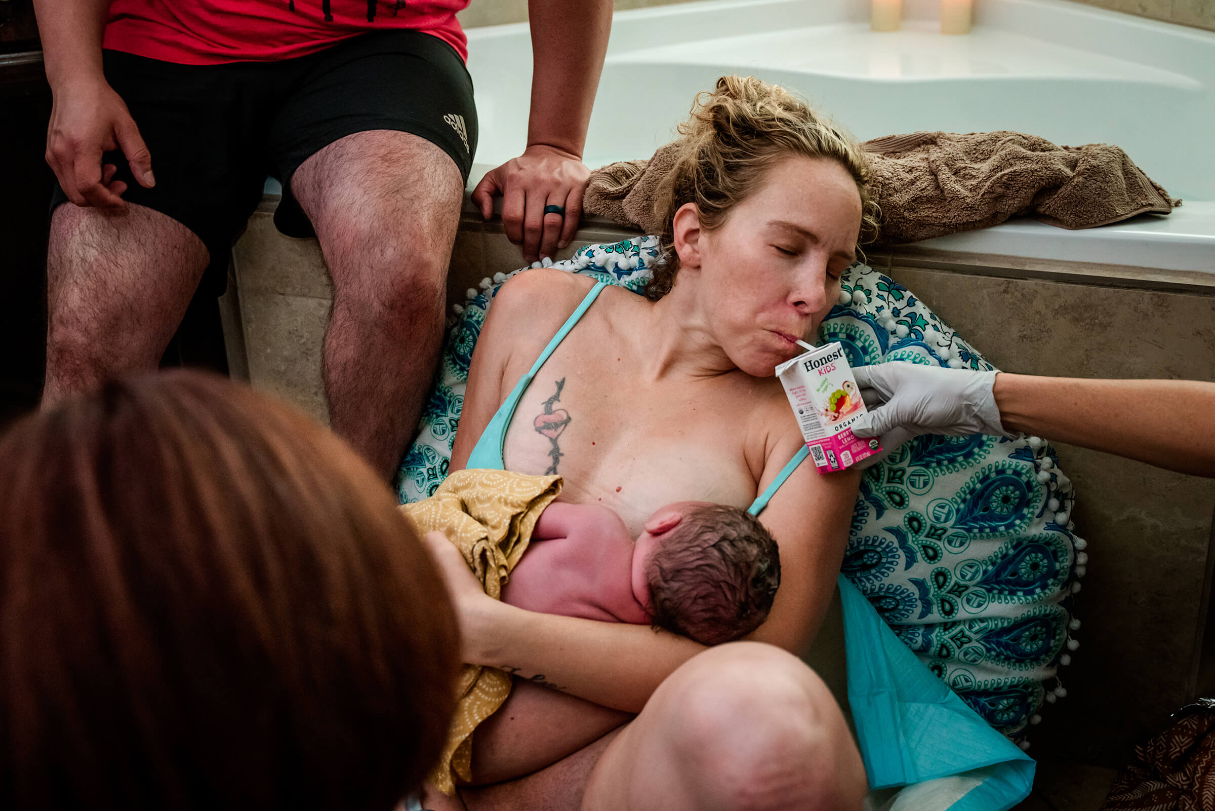 mother hydrating after home birth