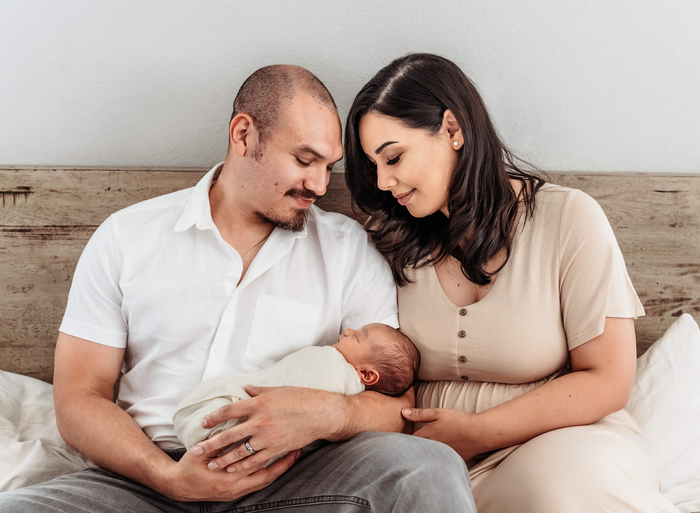 mom and dad with newborn in home session 