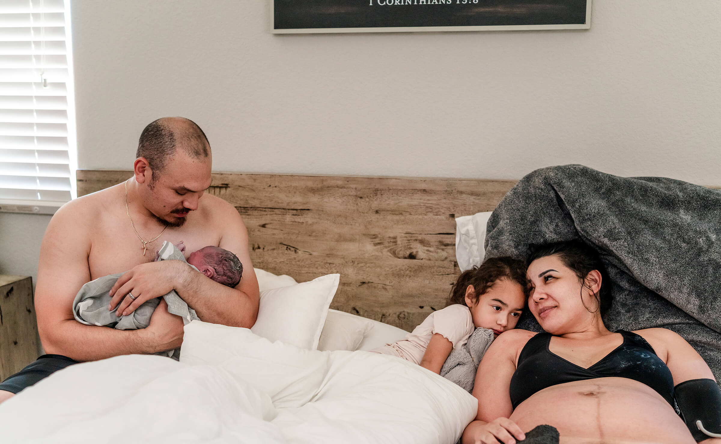 family together on bed after home birth 