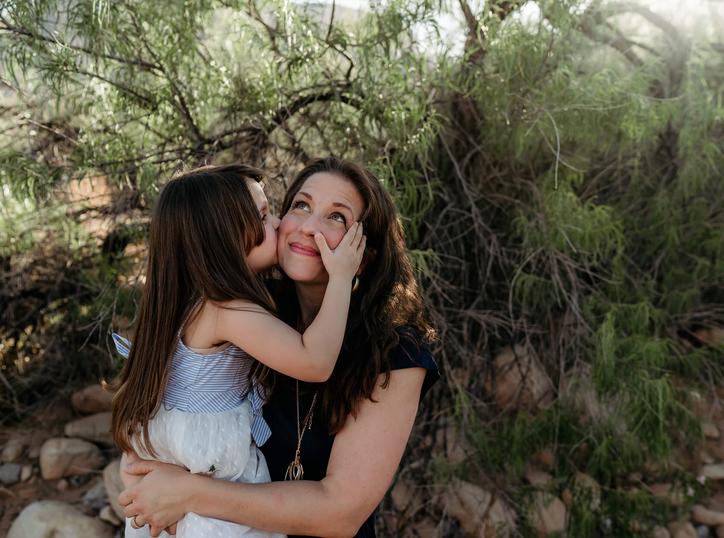 mother kissing her mom during a family session in Las Vegas