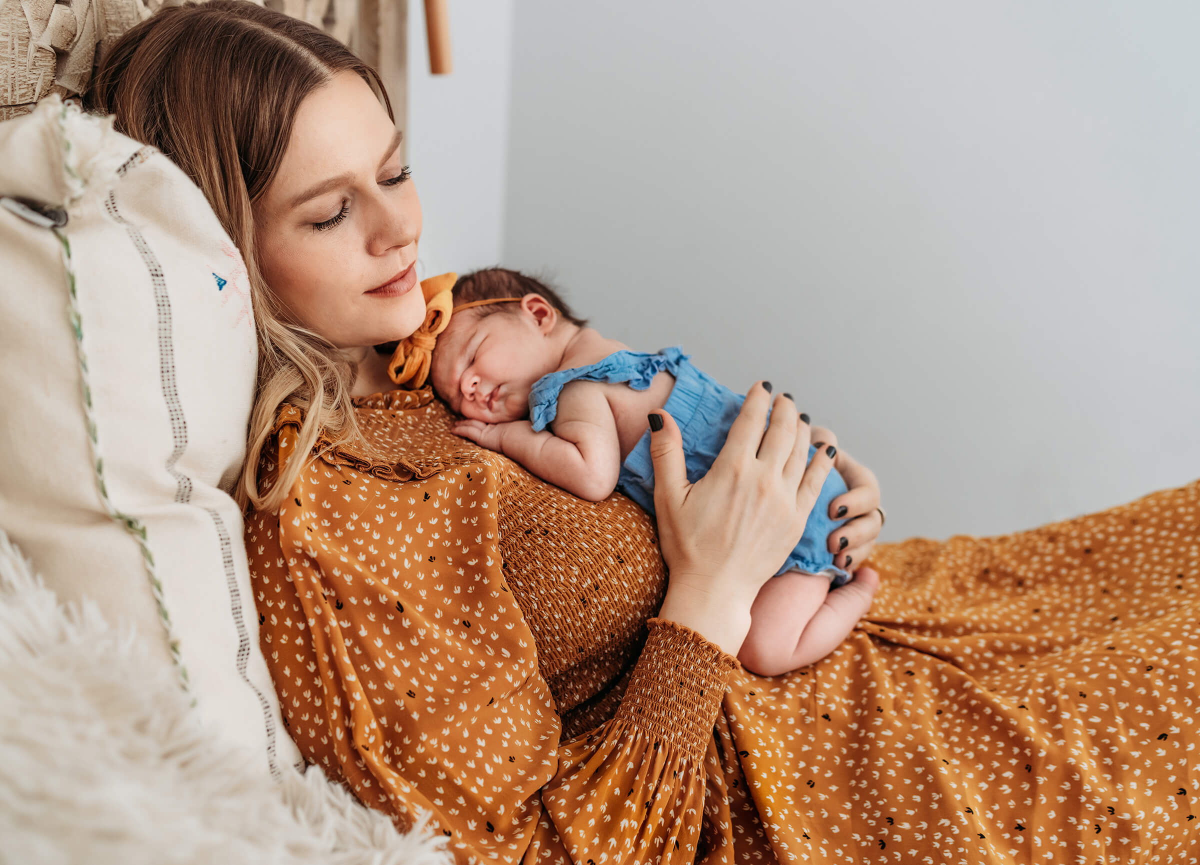 Danika holding her daughter during newborn session 