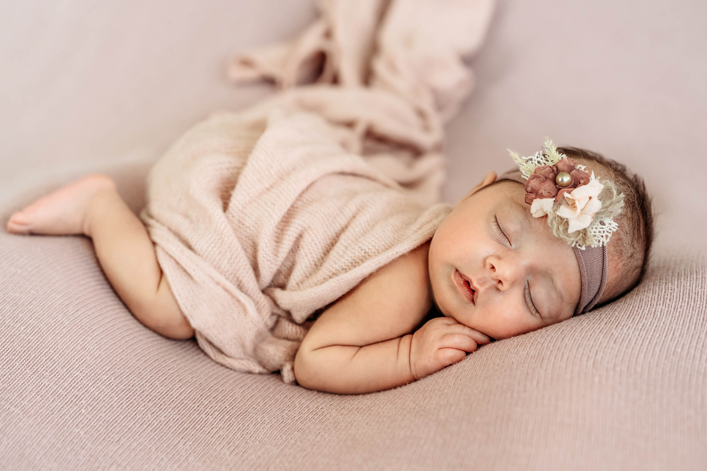 in-home newborn session with peach wrap