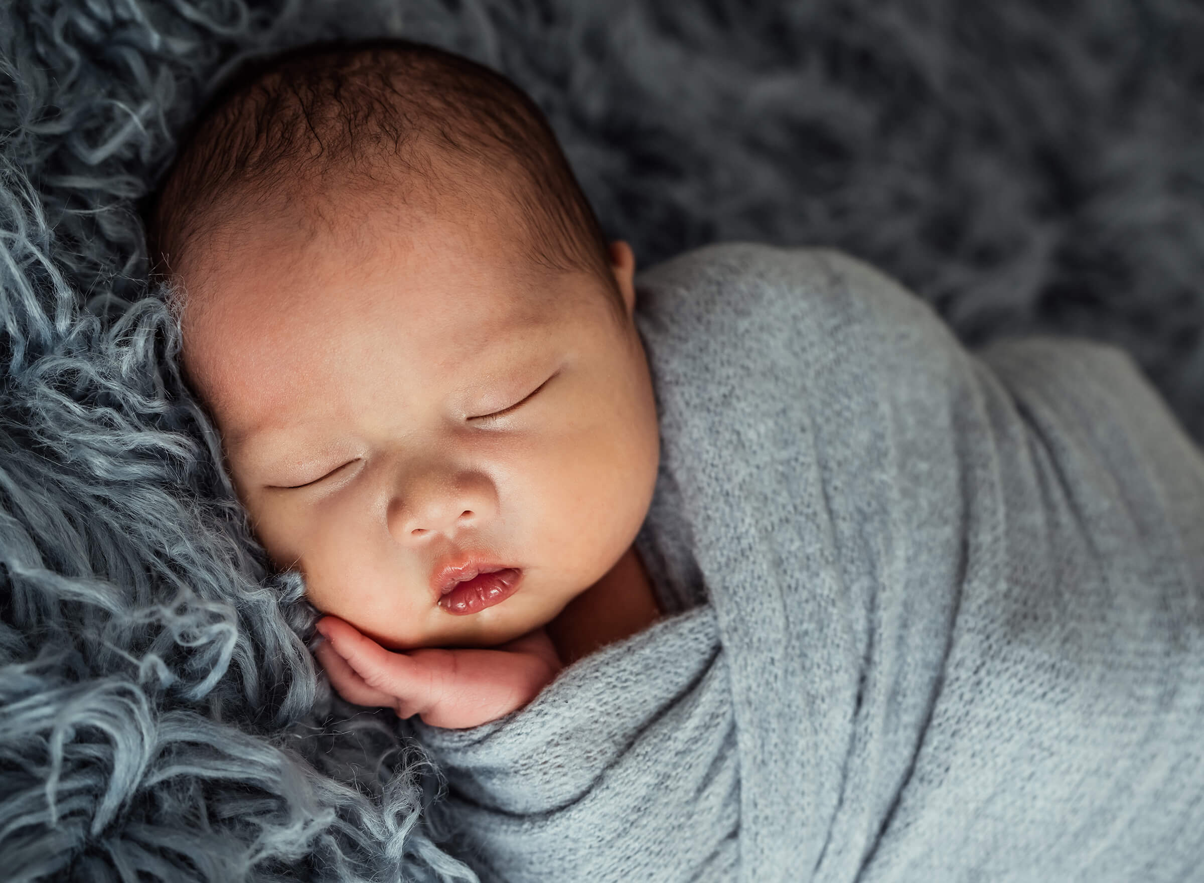 newborn session with blue swaddle