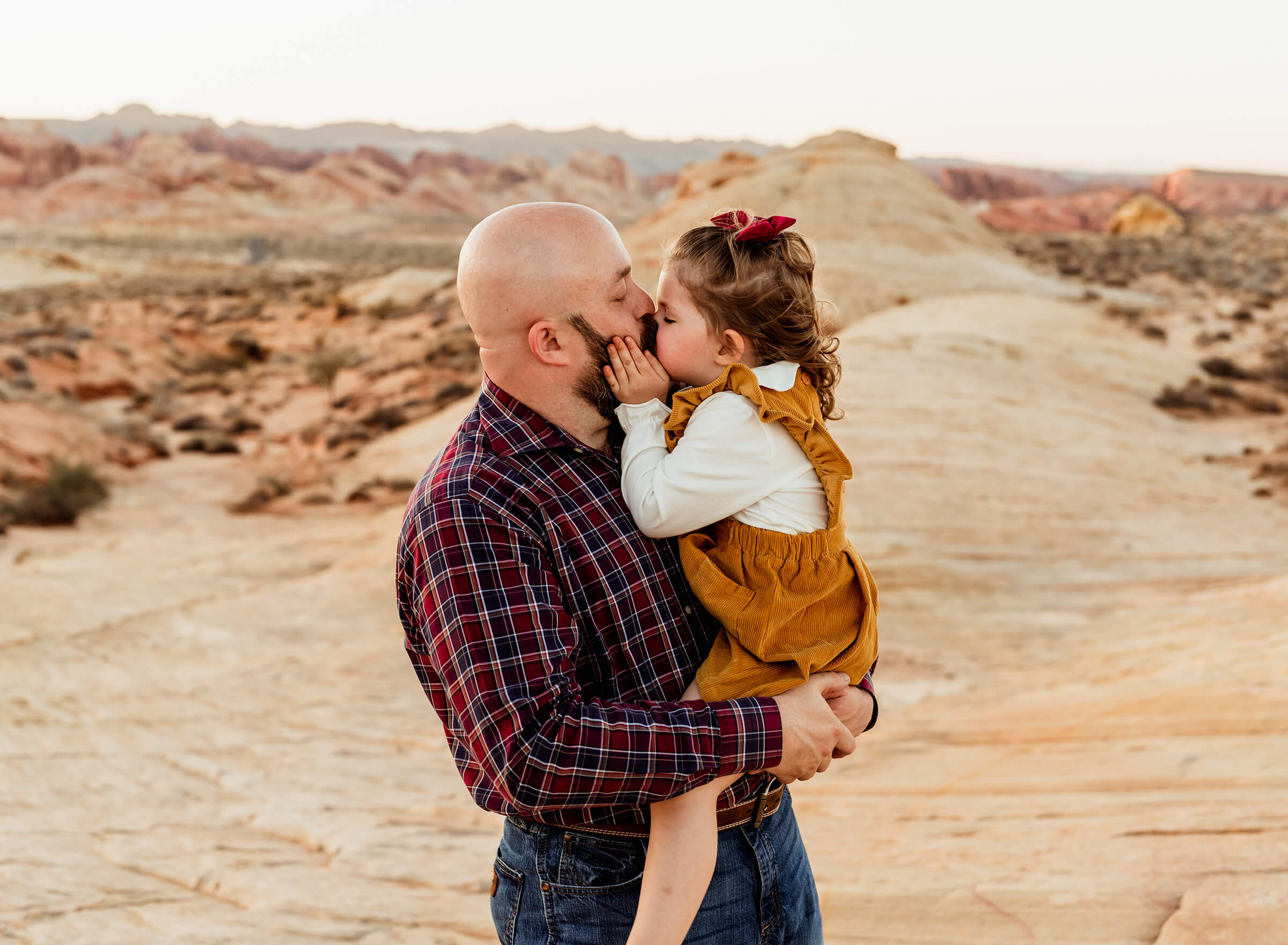 Dad holding daughter during family session