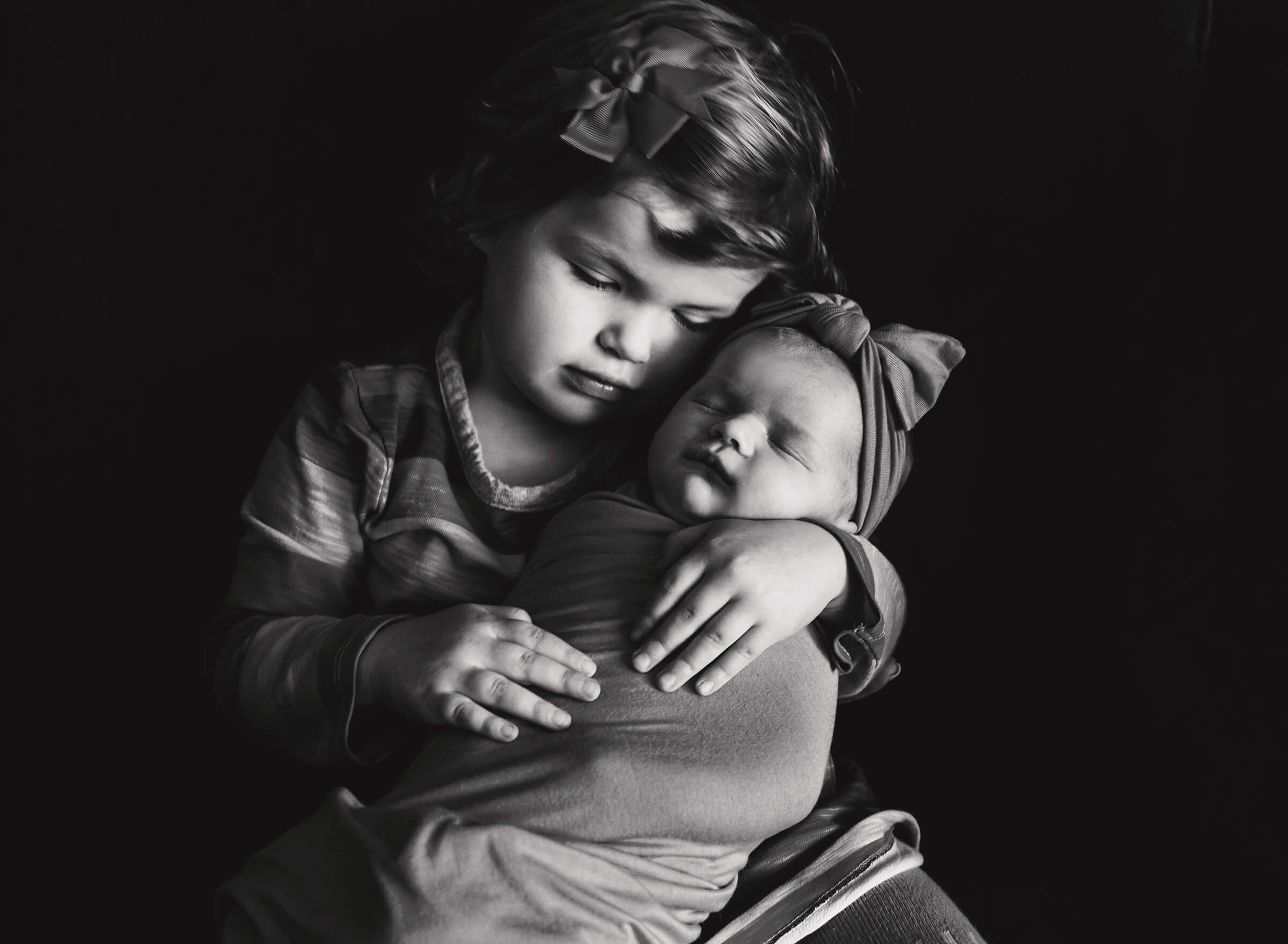 black and white image of two sisters during in home session.