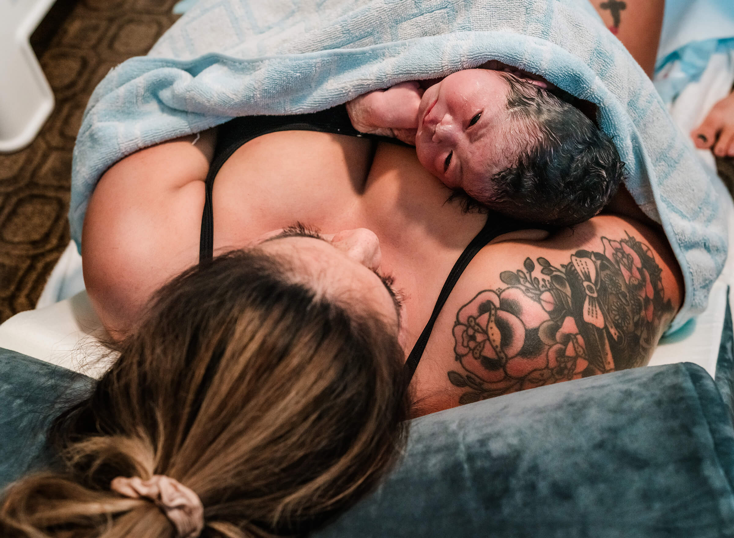 woman holds new baby in her arms after a home birth in Las Vegas.