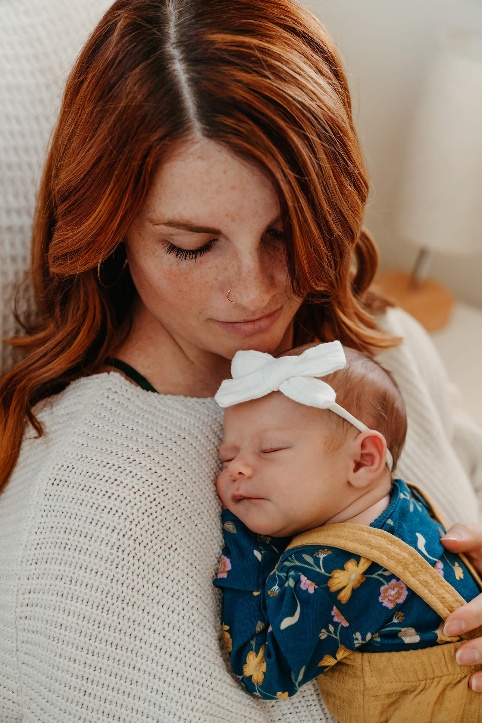 mother snuggling her new baby girl during a lifestyle newborn session in Las Vegas.