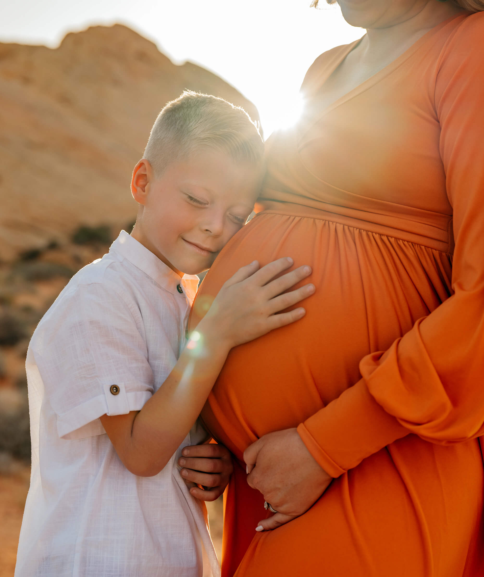 maternity session with son hugging his mother's stomach