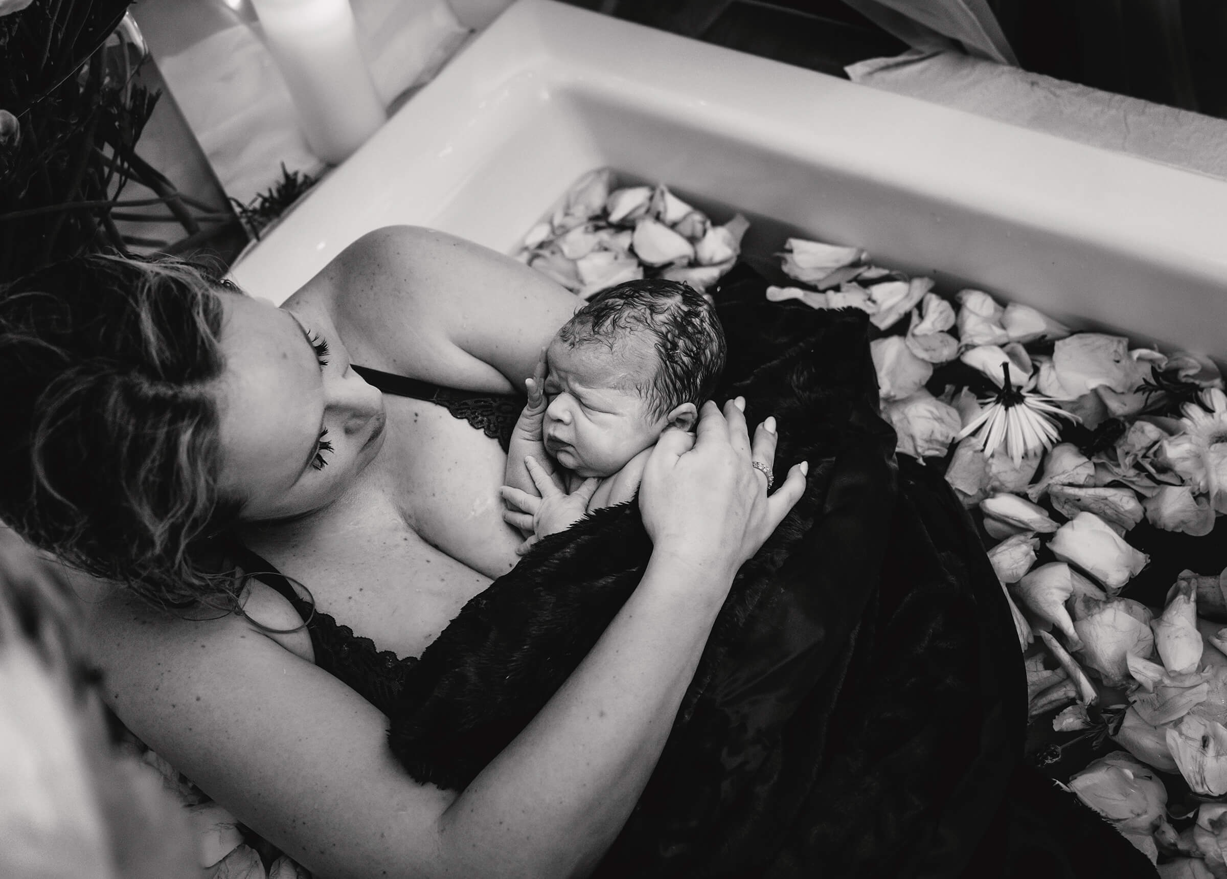black and white image of a mother holding her son right after delivery at her home in Las Vegas