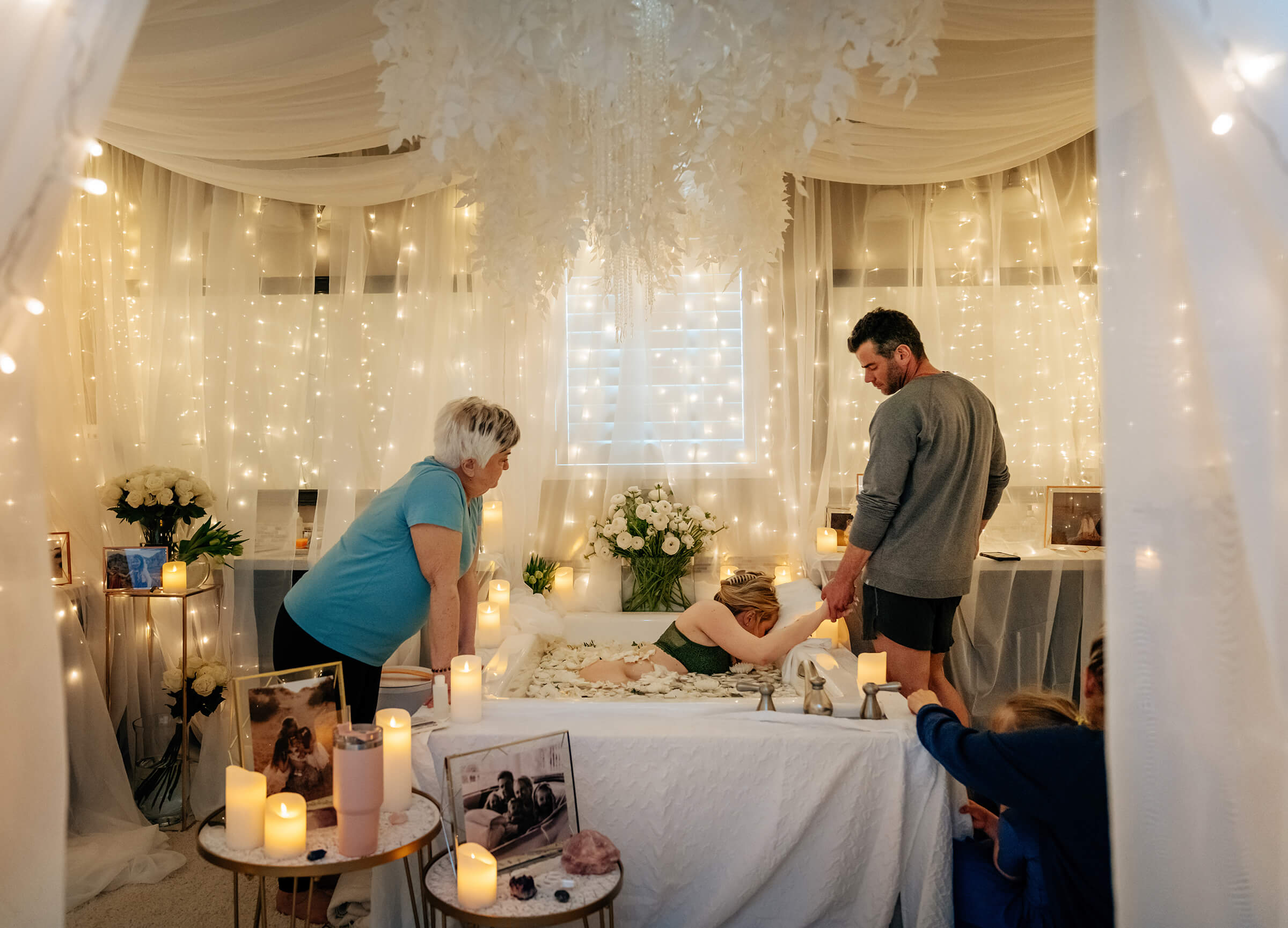 birth space decorated with white flowers and lights 