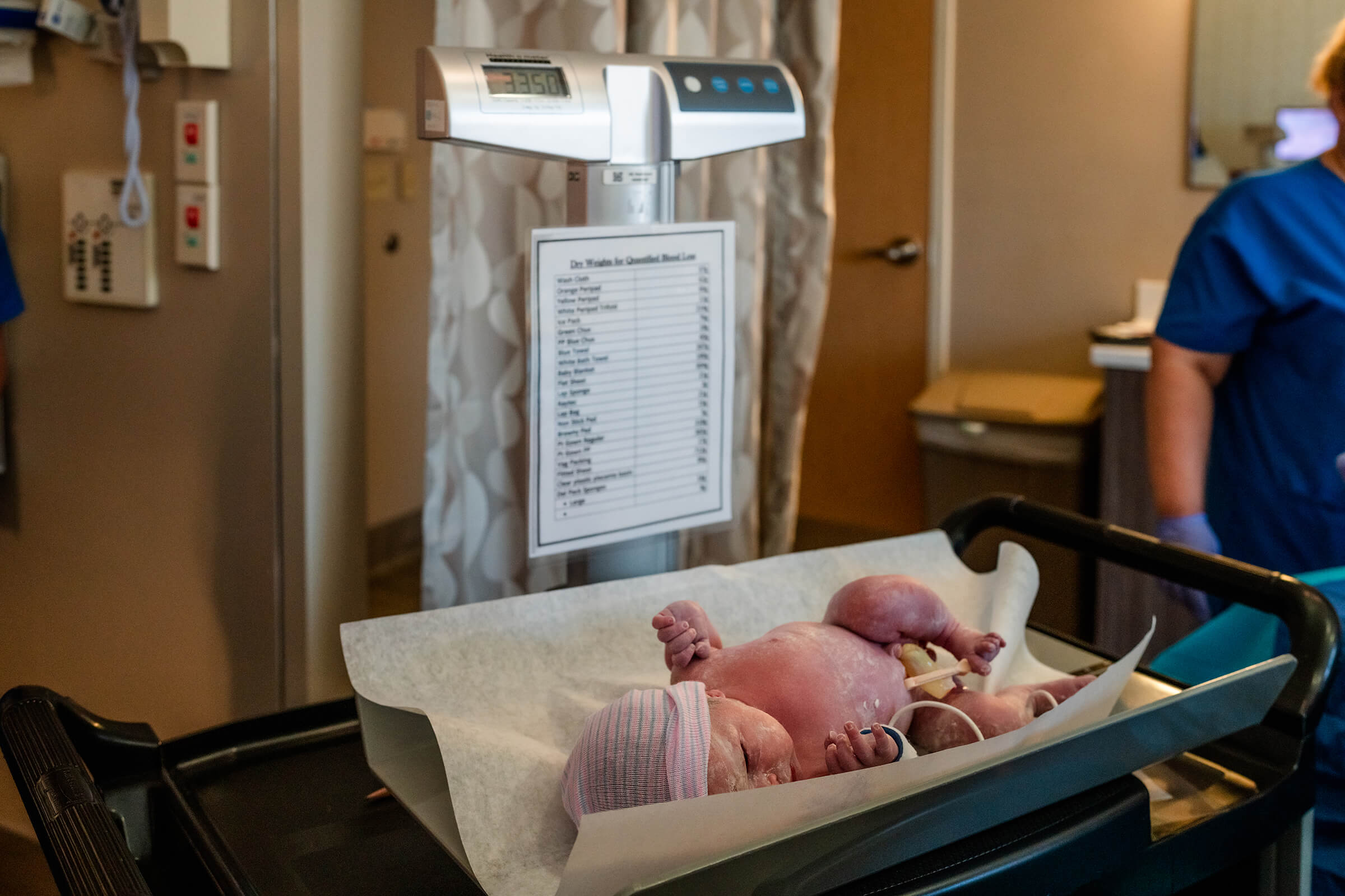 Newborn being weighed in the hospital after delivery. 