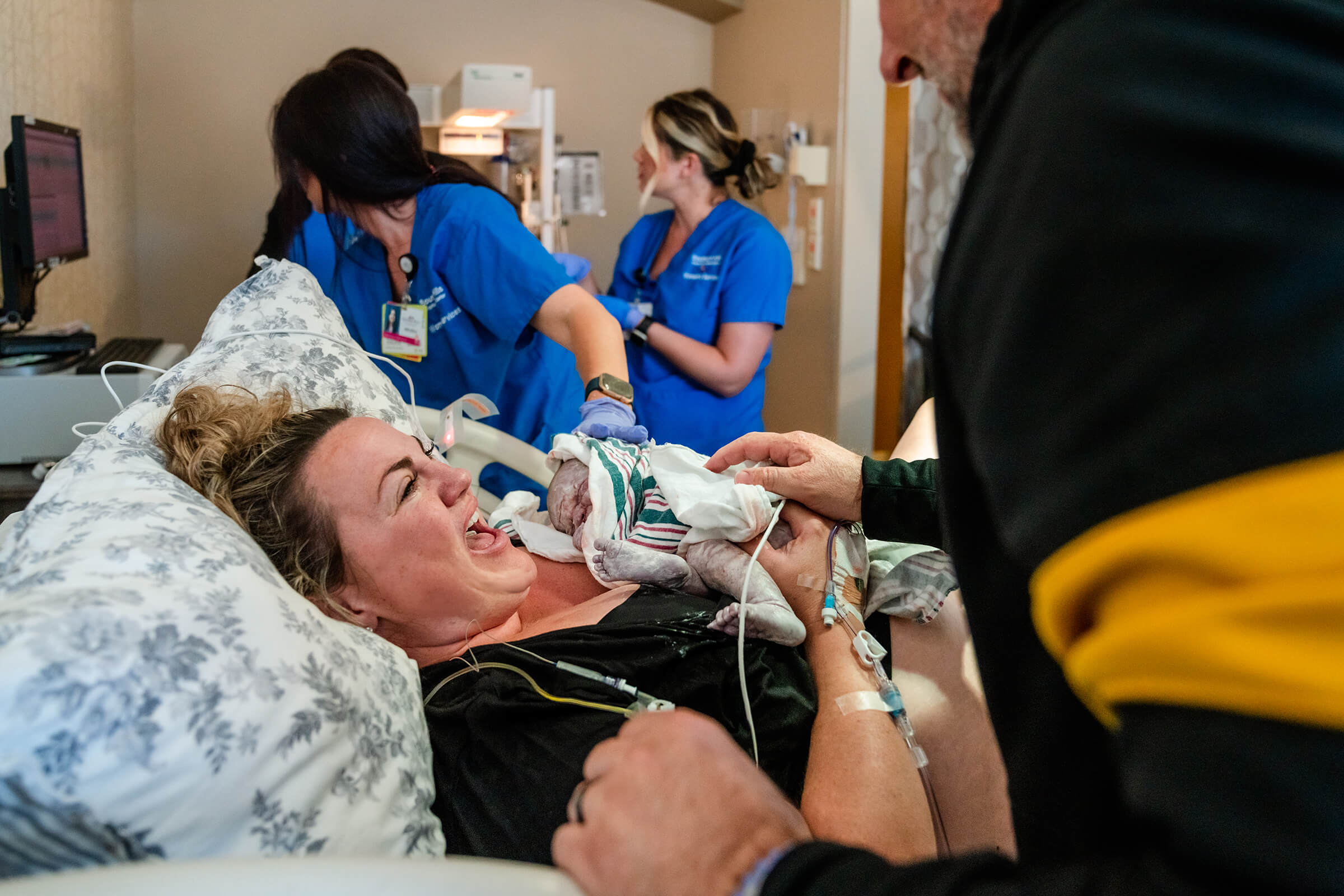 mother full of joy and excitement upon seeing her newborn baby for the first time