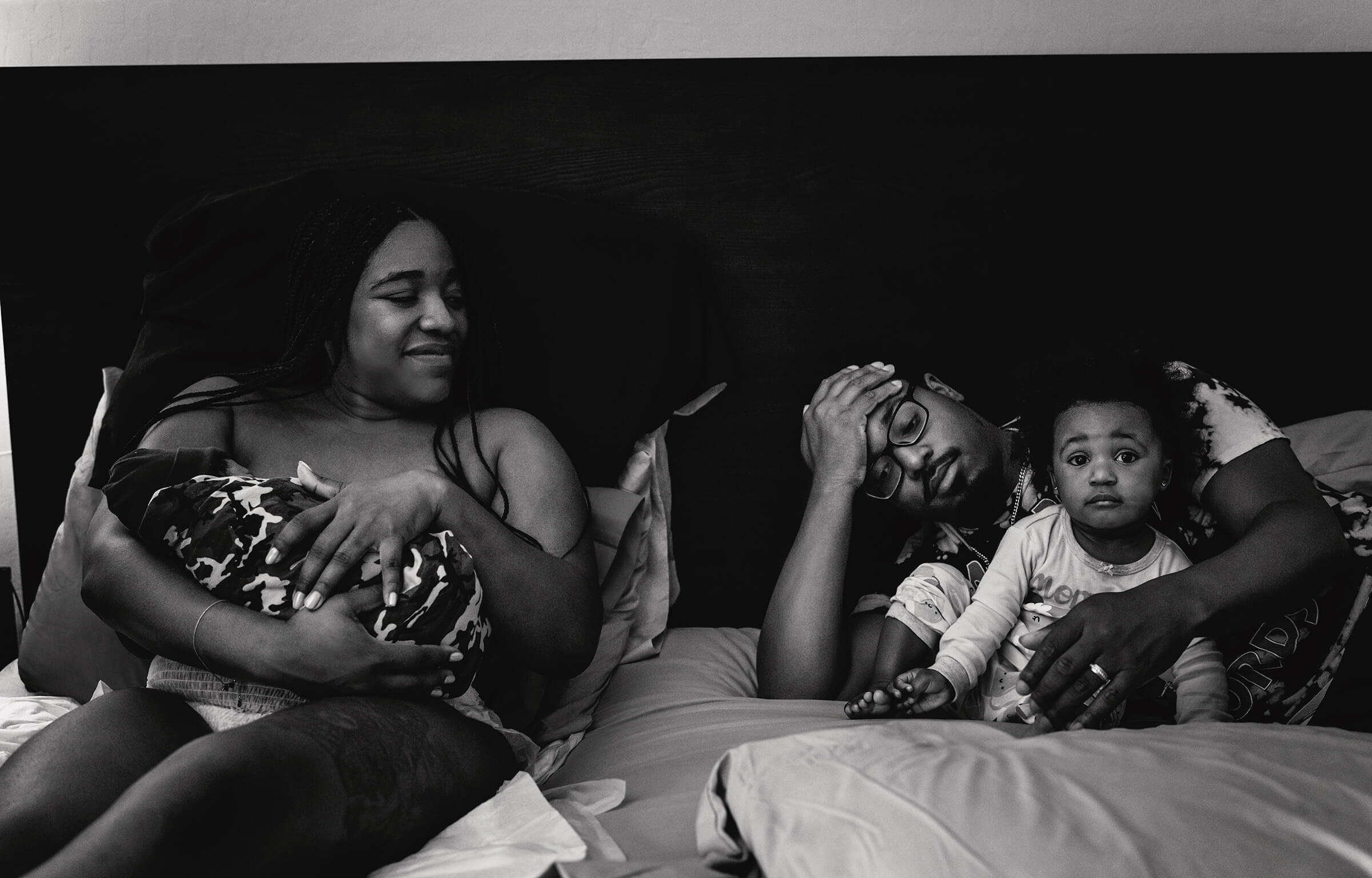 a beautiful black family together on the bed after a fast homebirth in Henderson