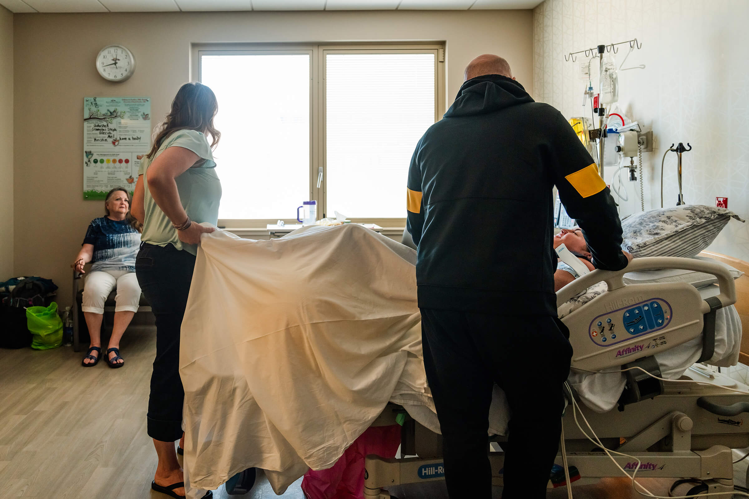 family surrounding a hospital bed of a woman in labor at Southern Hills Hospital in Las Vegas