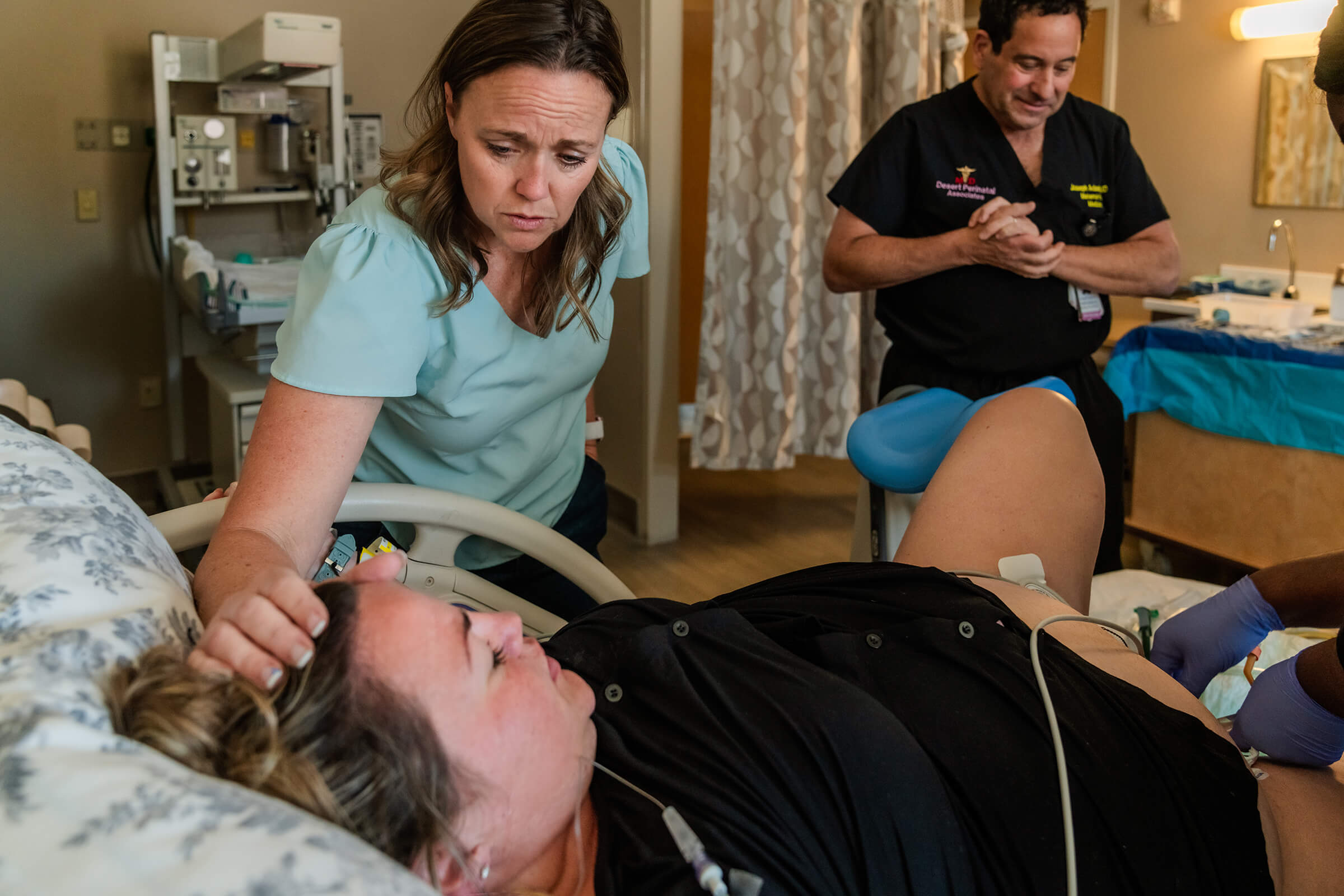 sister providing emotional and physical support while her sister delivers a baby at Southern Hills Hospital